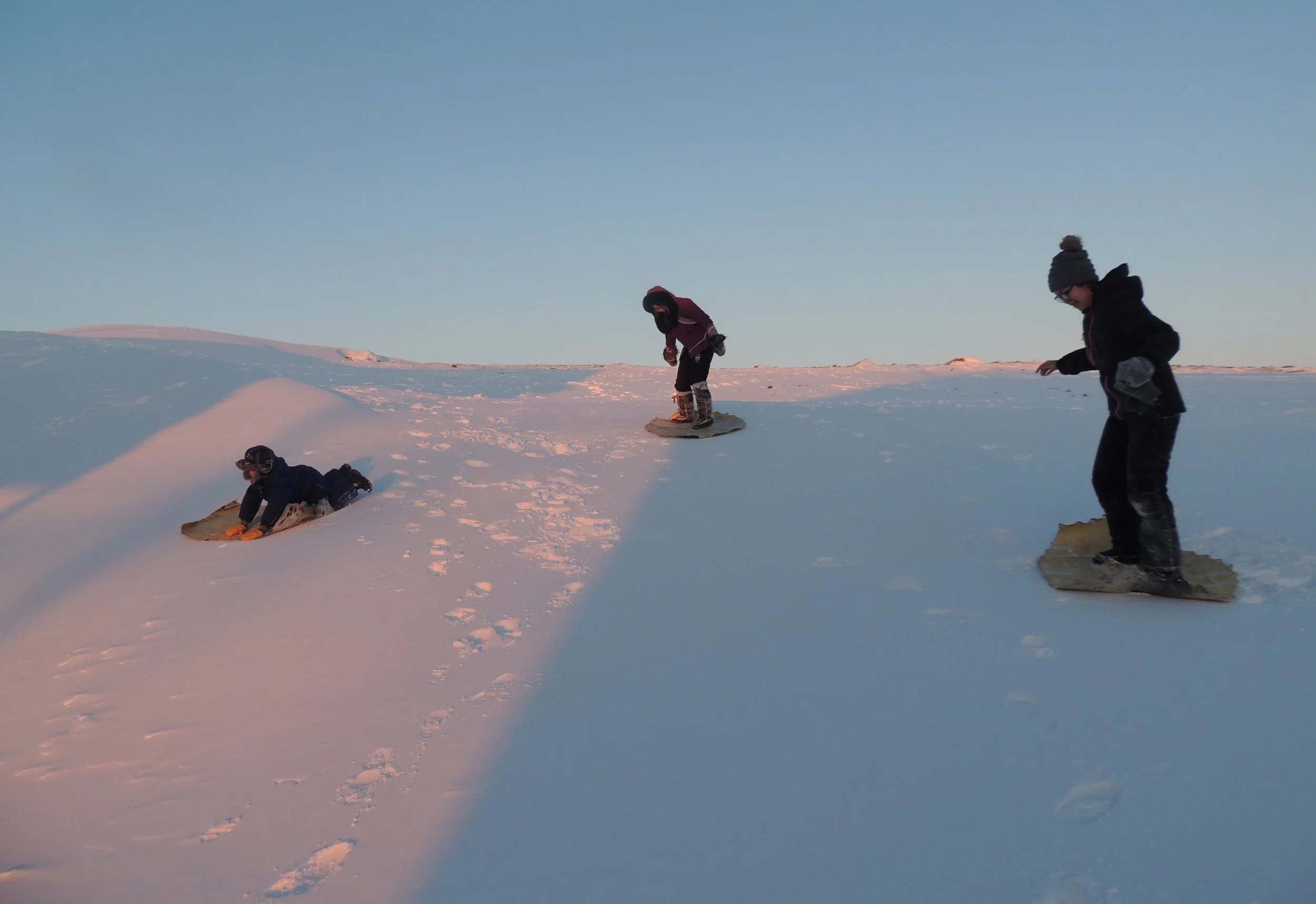 'Sliding/Skate Board' by Gayle Umphrey, Iqaluit (cleaning skins while having fun)