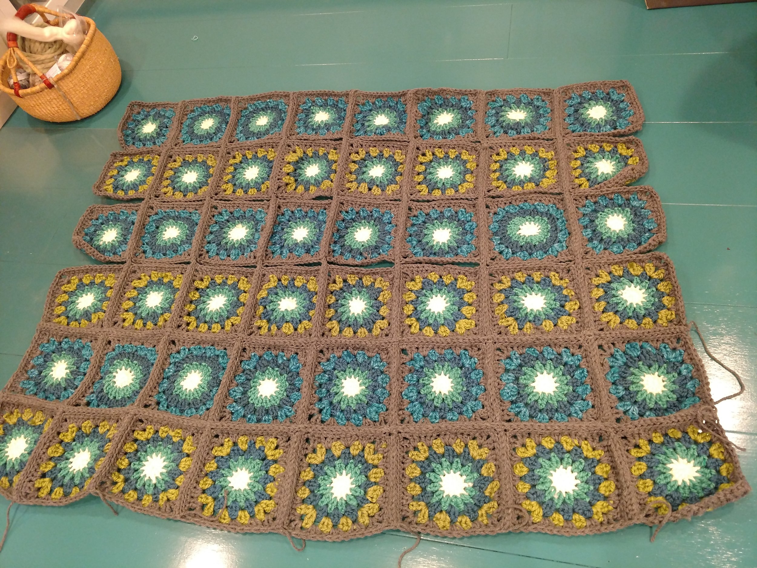 halfway joined. the squares are all slip stitched together in vertical columns, and are halfway attached by rows (from the bottom up)