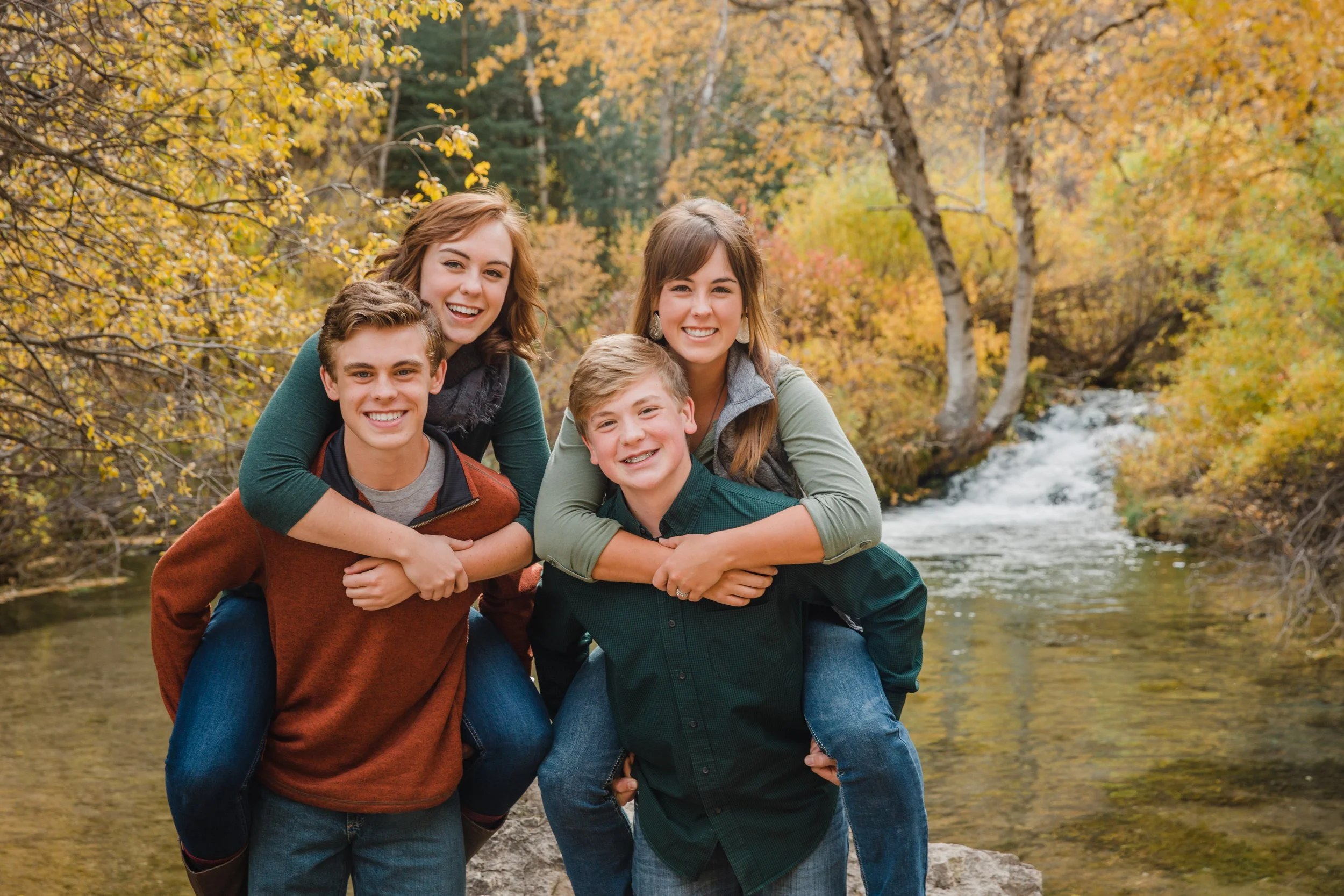siblings wearing neutral colors at roughneck falls near spearfish canyon in South Dakota