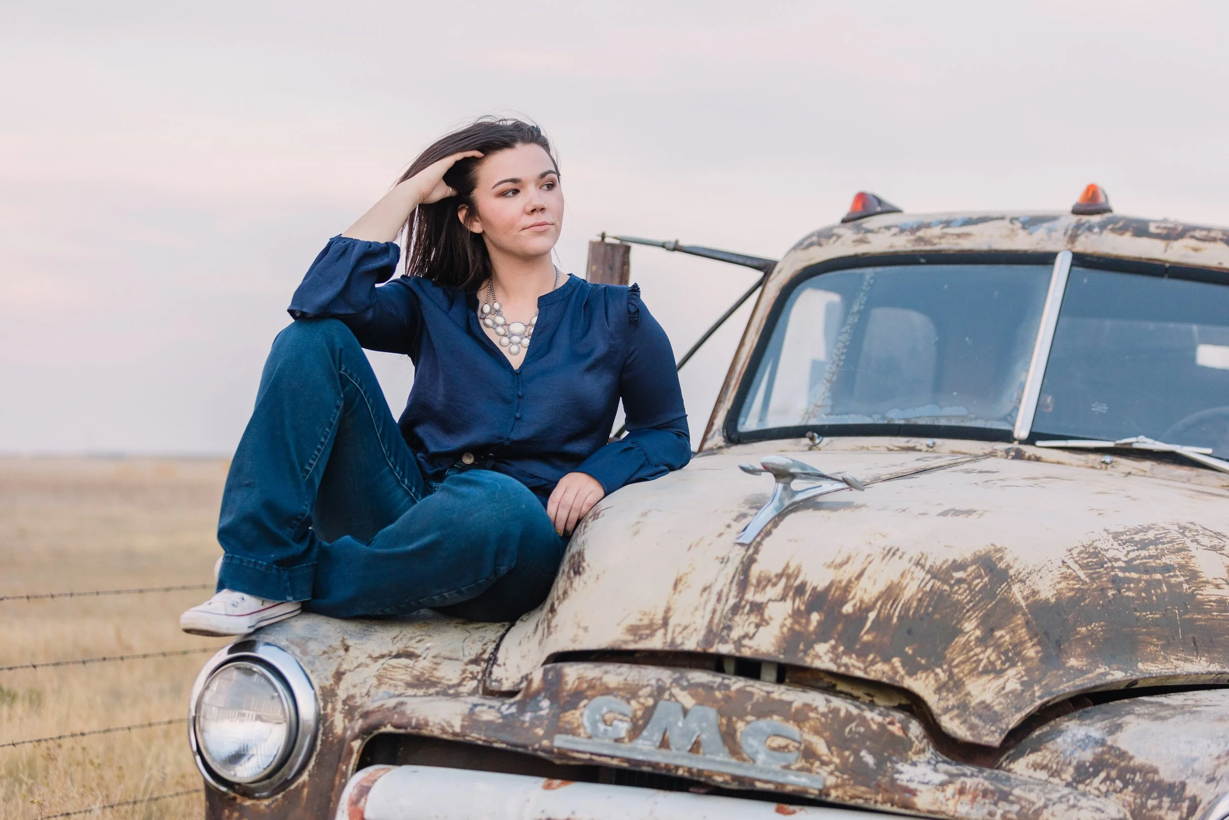senior posing by an old truck near new underwood sd