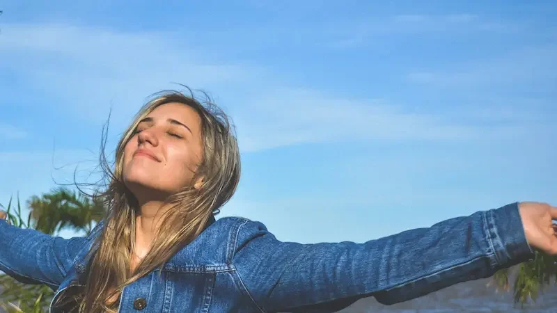 Woman smiling with outstretched arms
