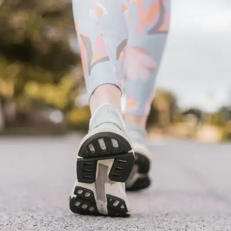 Sneakers as a woman is taking steps.