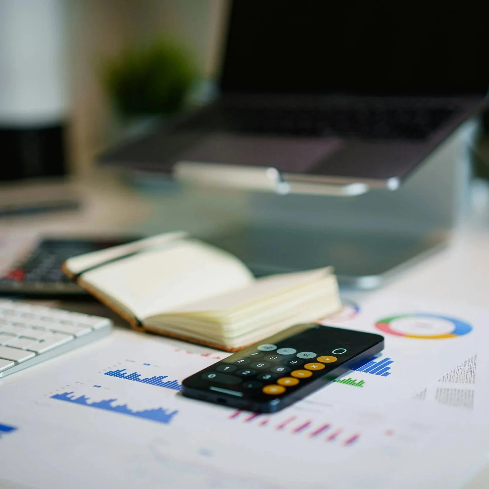 A desk with papers, books and a calculator.