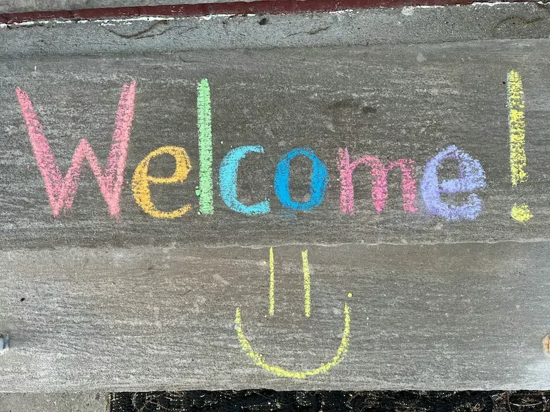 Welcome sign with smiley face.