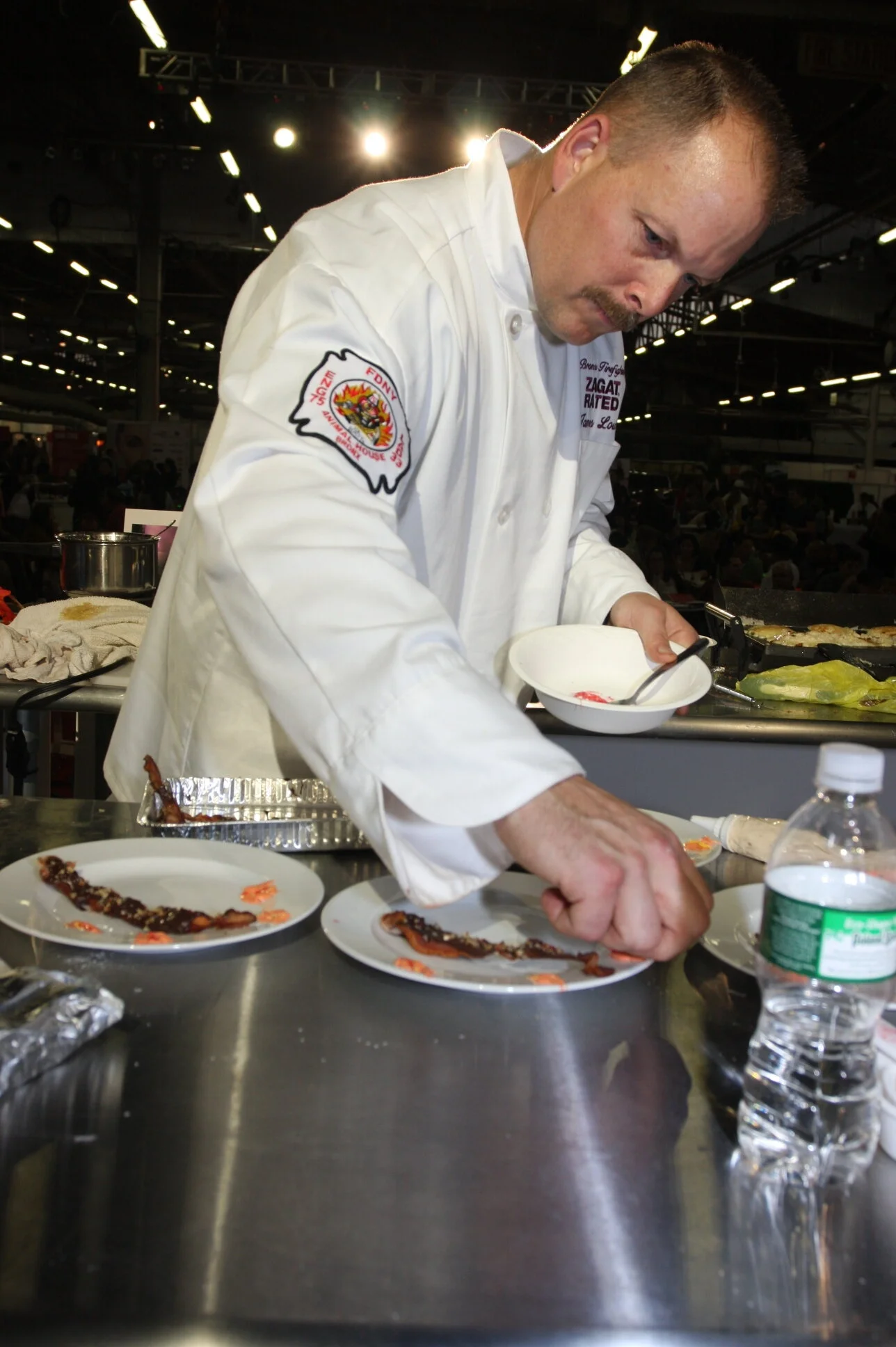  November 8th 2008: New York NY: At the 1st annual FDNY Pancake Cookoff one of the five finalists preps his plate to be served to the judges.Photographed by Michelle Farsi848-702-3123(cell) mfarsi2@mac.com (email) 