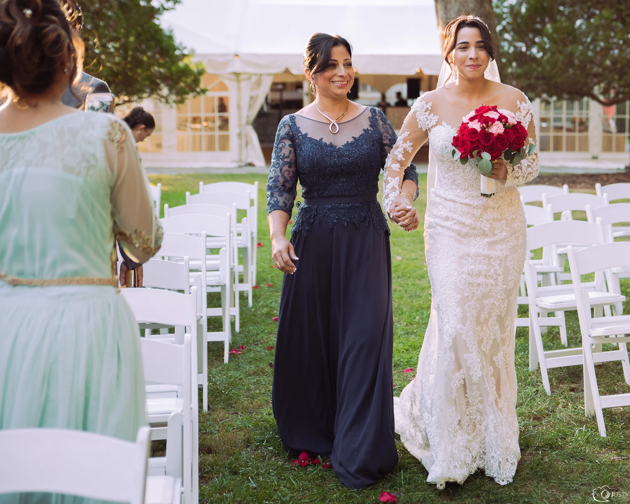 Bride and her mom walking down the isle - Strong Mansion Wedding