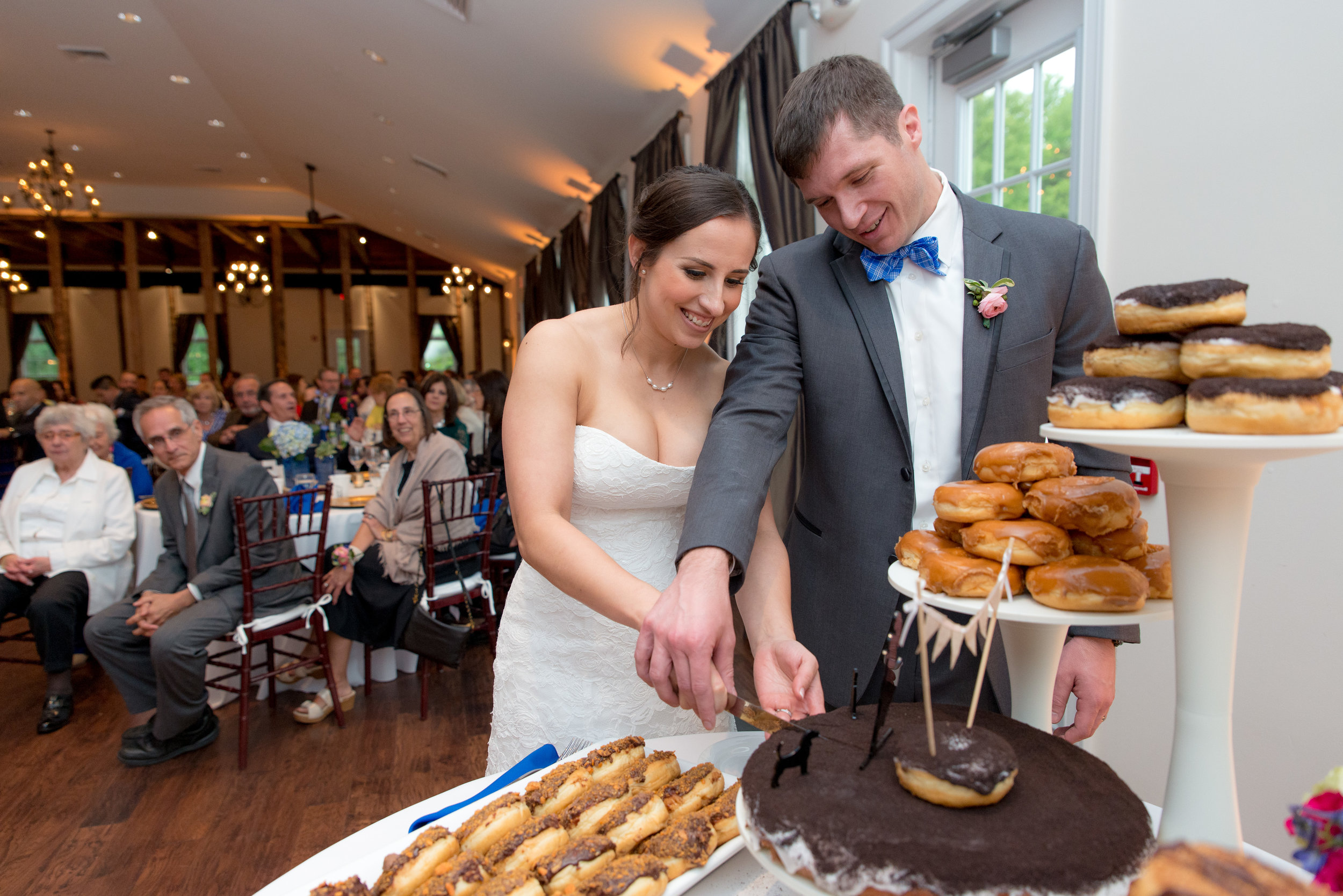  Bride and Groom Cutting a giant donut cake by Sugar Shack 