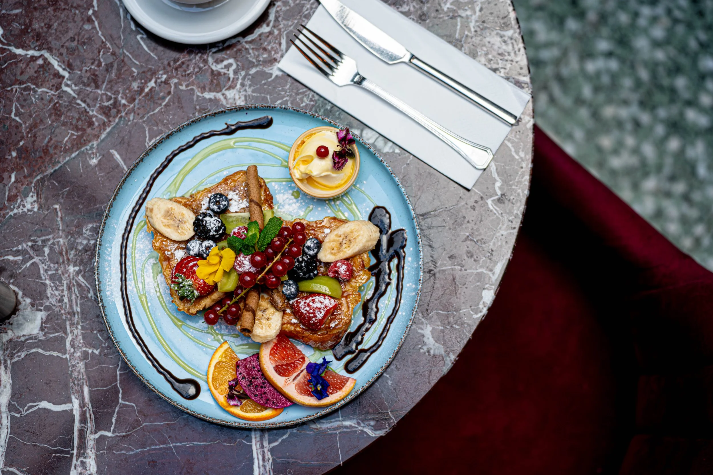 Overhead view of a brunch plate with pastries and fruit