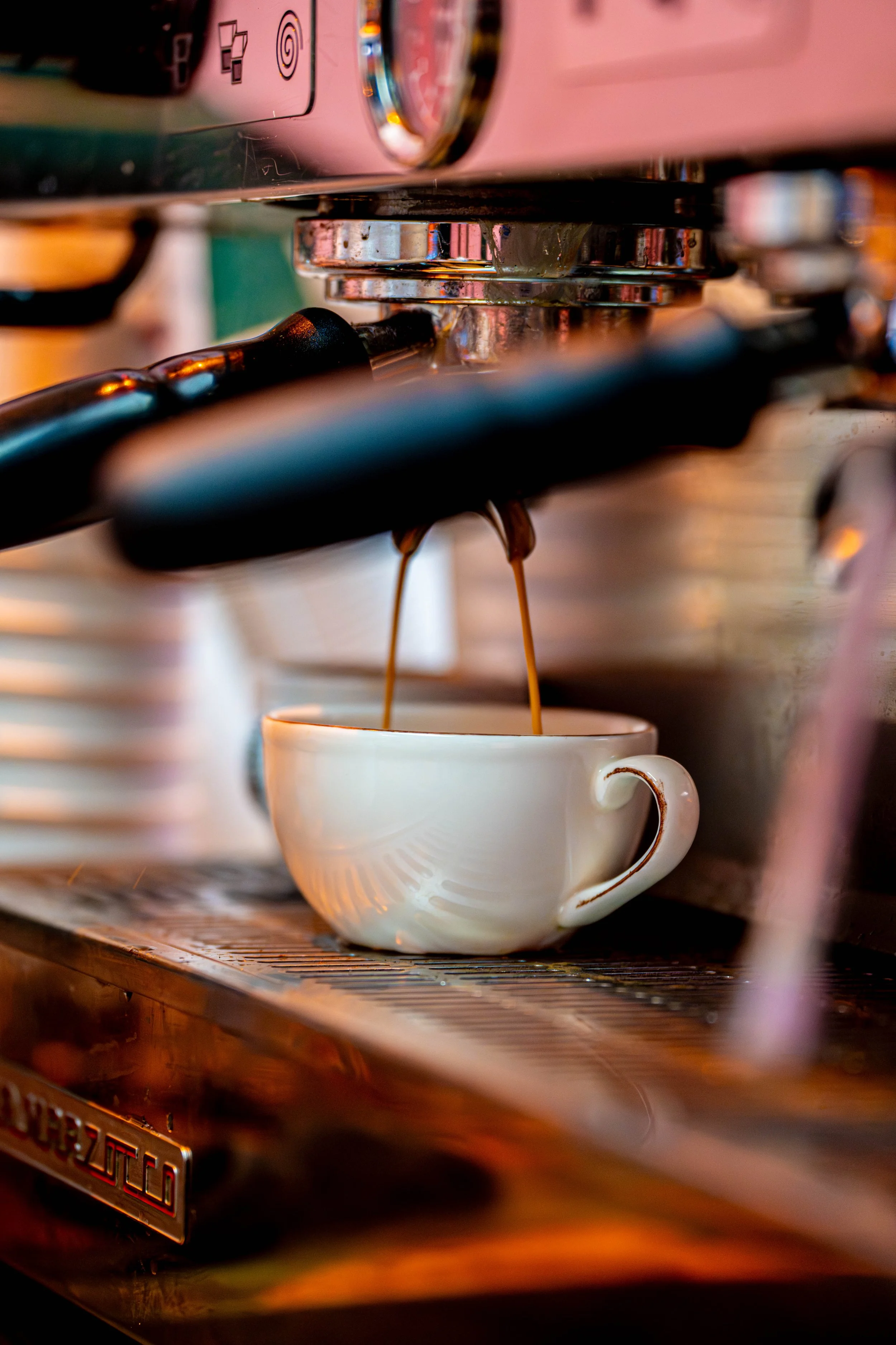 Barista pouring coffee into a cup at a London cafe