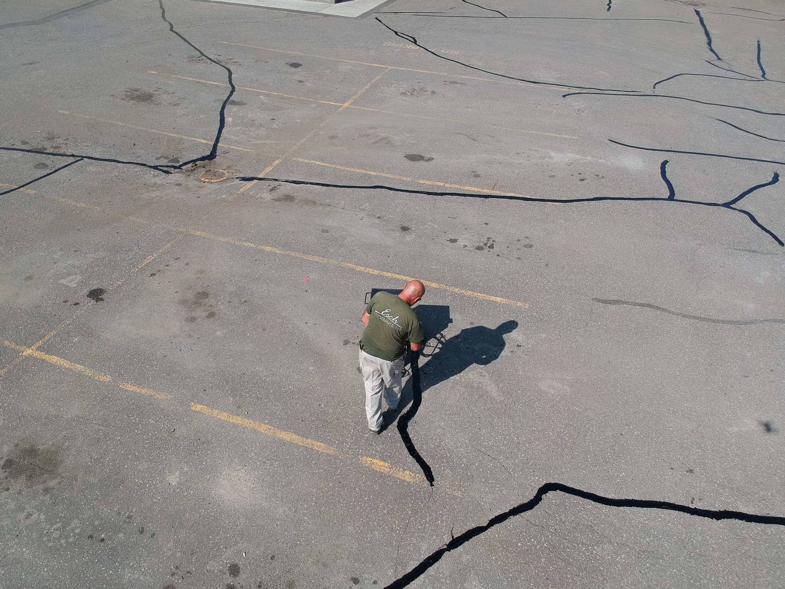 Esch Landscaping -Asphalt - Crack Fill in Progress Aerial Shot of Commercial Parking Lot.JPG