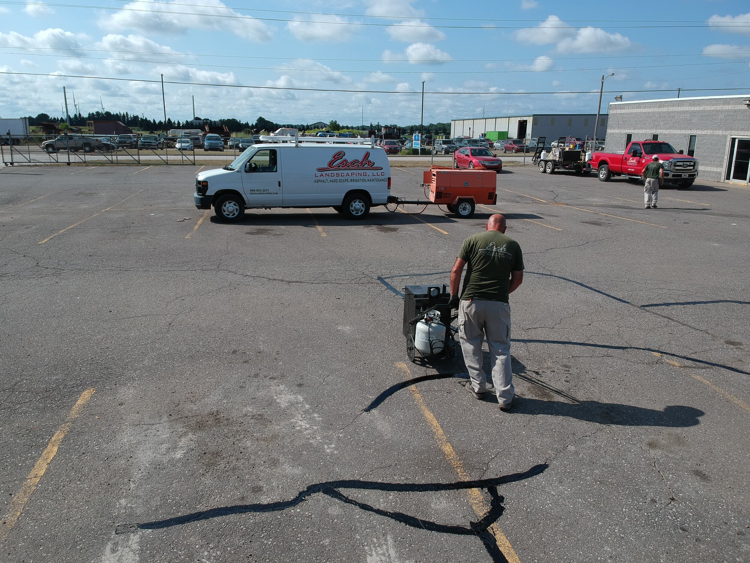 Esch Landscaping -Asphalt - Crack Fill in Progress Commercial Parking Lot.JPG