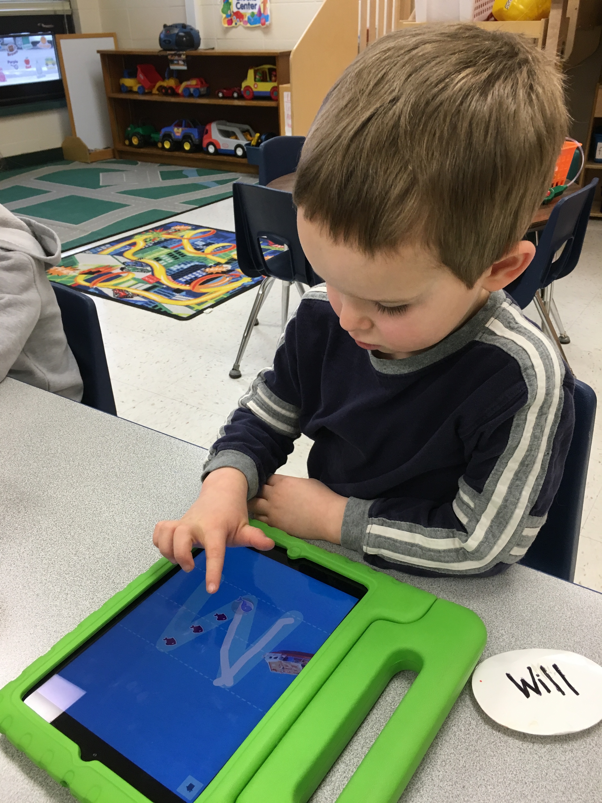 Tracing uppercase letters on the app called Letter Writing. 