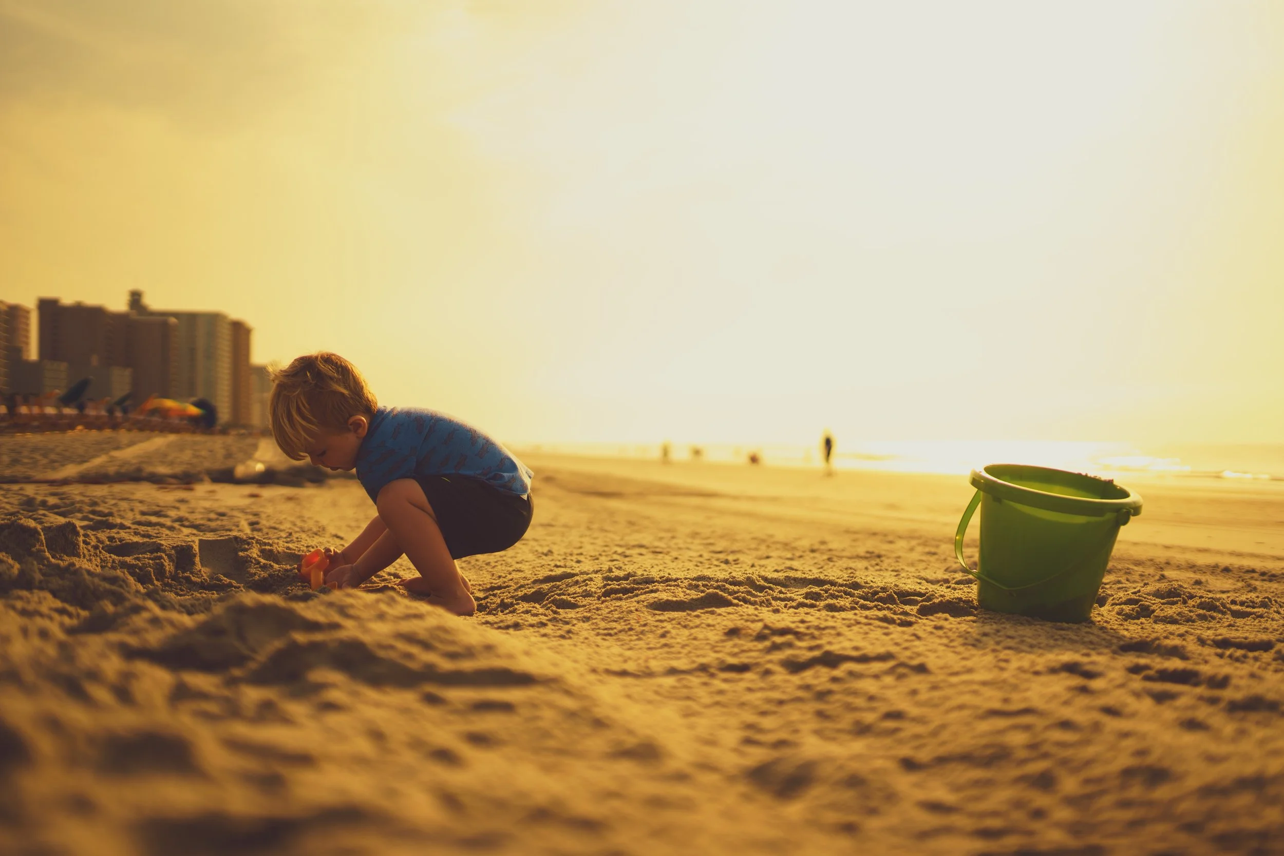 boy squatting on beach.jpg