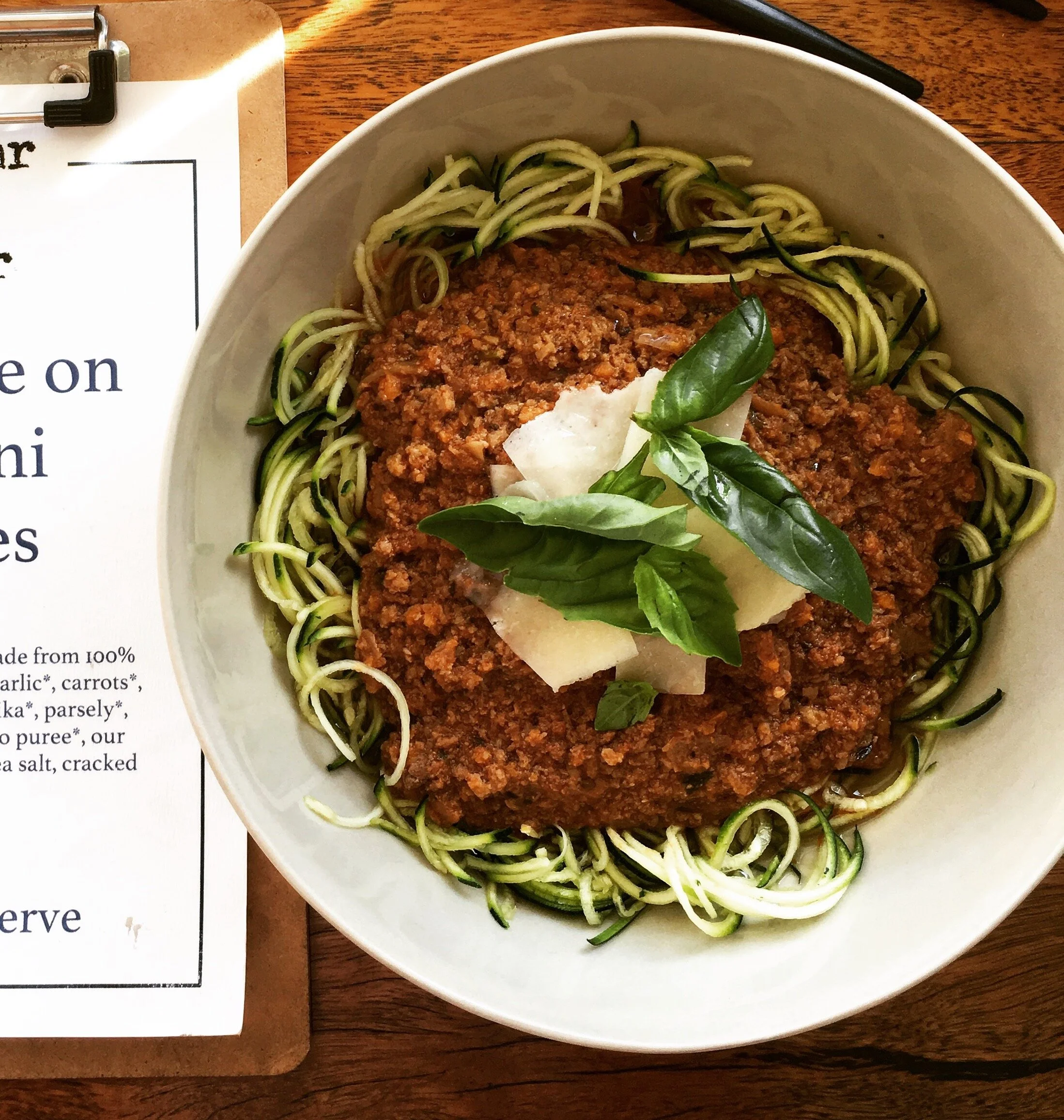 Sneaky Bolognese served with zucchini noodles, fresh basil, and shaved parmesan – made with grass-fed beef and bone broth