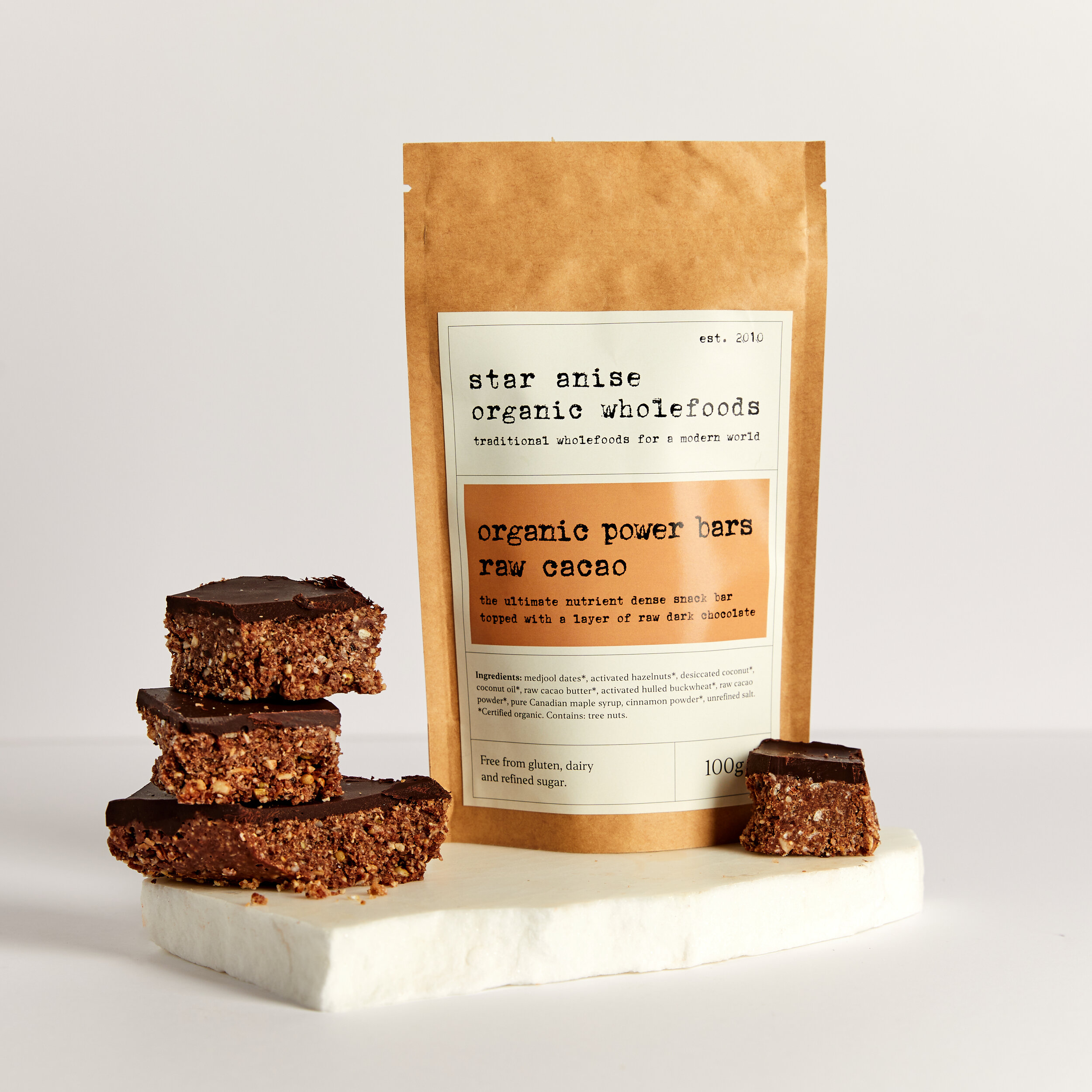 Organic Raw Cacao Power Bars stacked with pouch – nutrient-dense snack made with activated nuts and no refined sugar