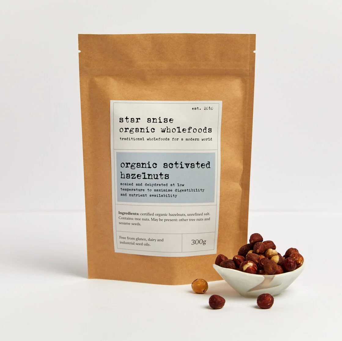 Organic activated hazelnuts in kraft bag with small bowl – soaked and dehydrated for better digestion and nutrient absorption