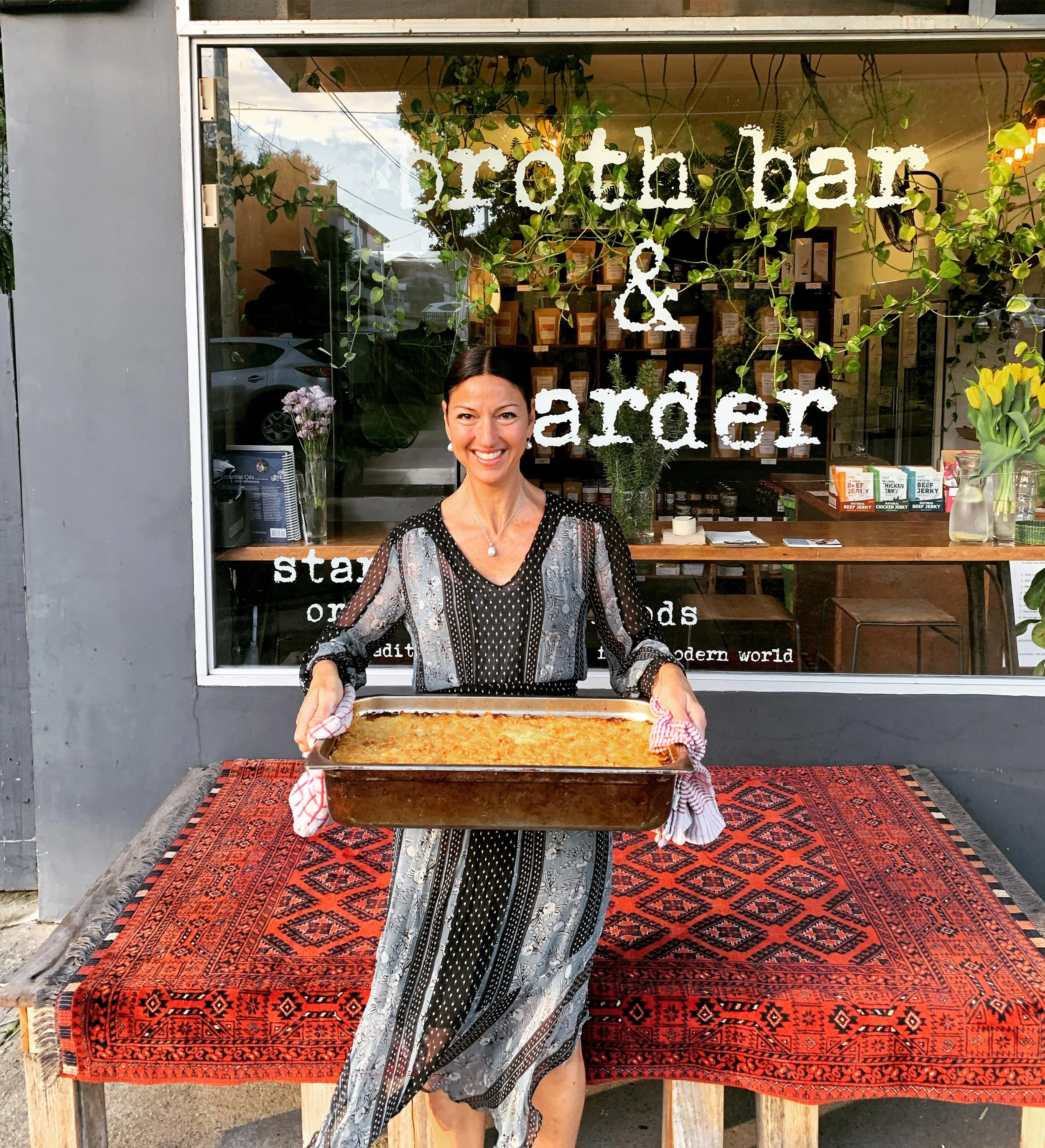 Shepherd’s pie fresh from the oven held outside Broth Bar & Larder – made with beef, broth, and gruyere