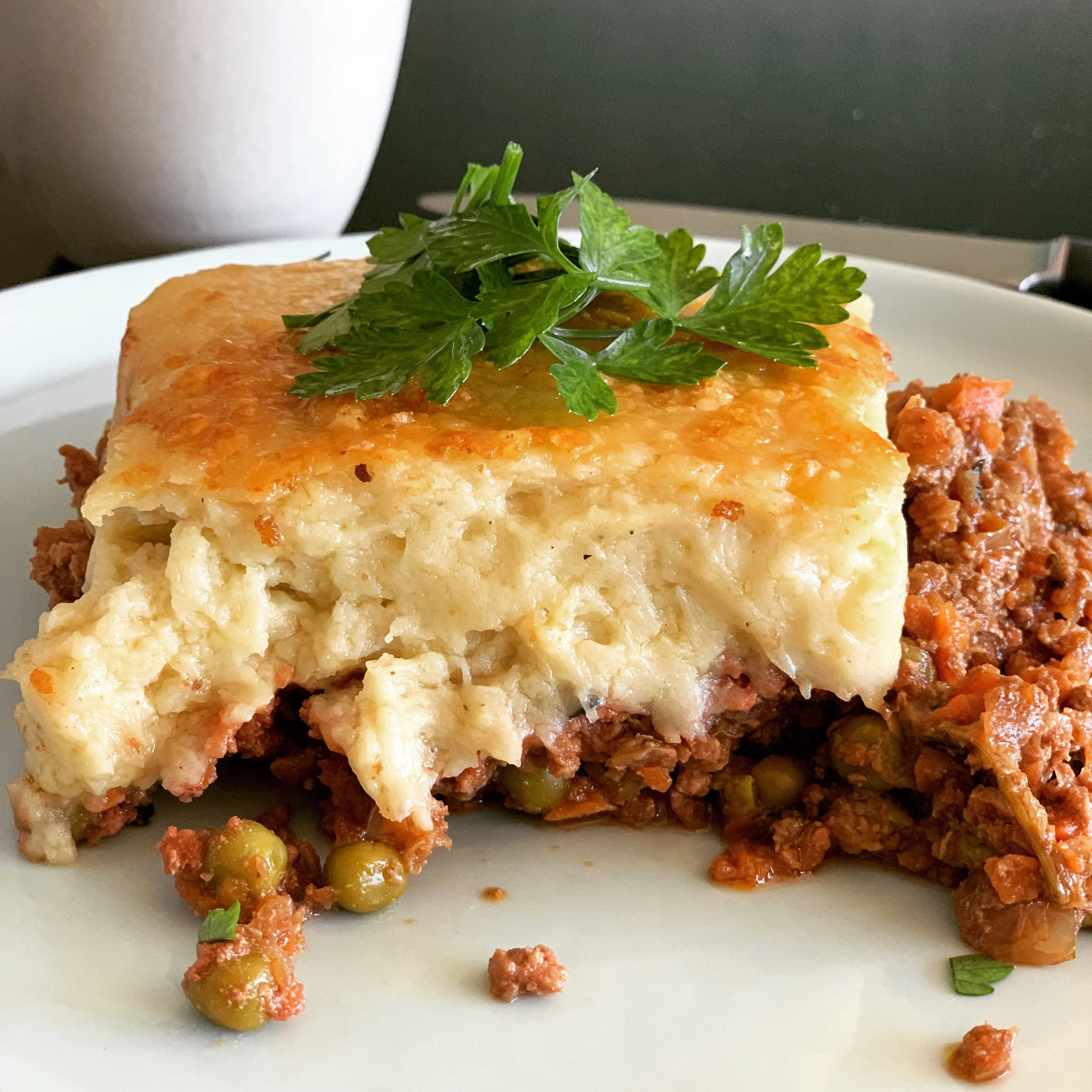 Slice of shepherd’s pie with mashed potato topping, peas, and grass-fed beef – nutrient-dense ready meal with broth and cheese
