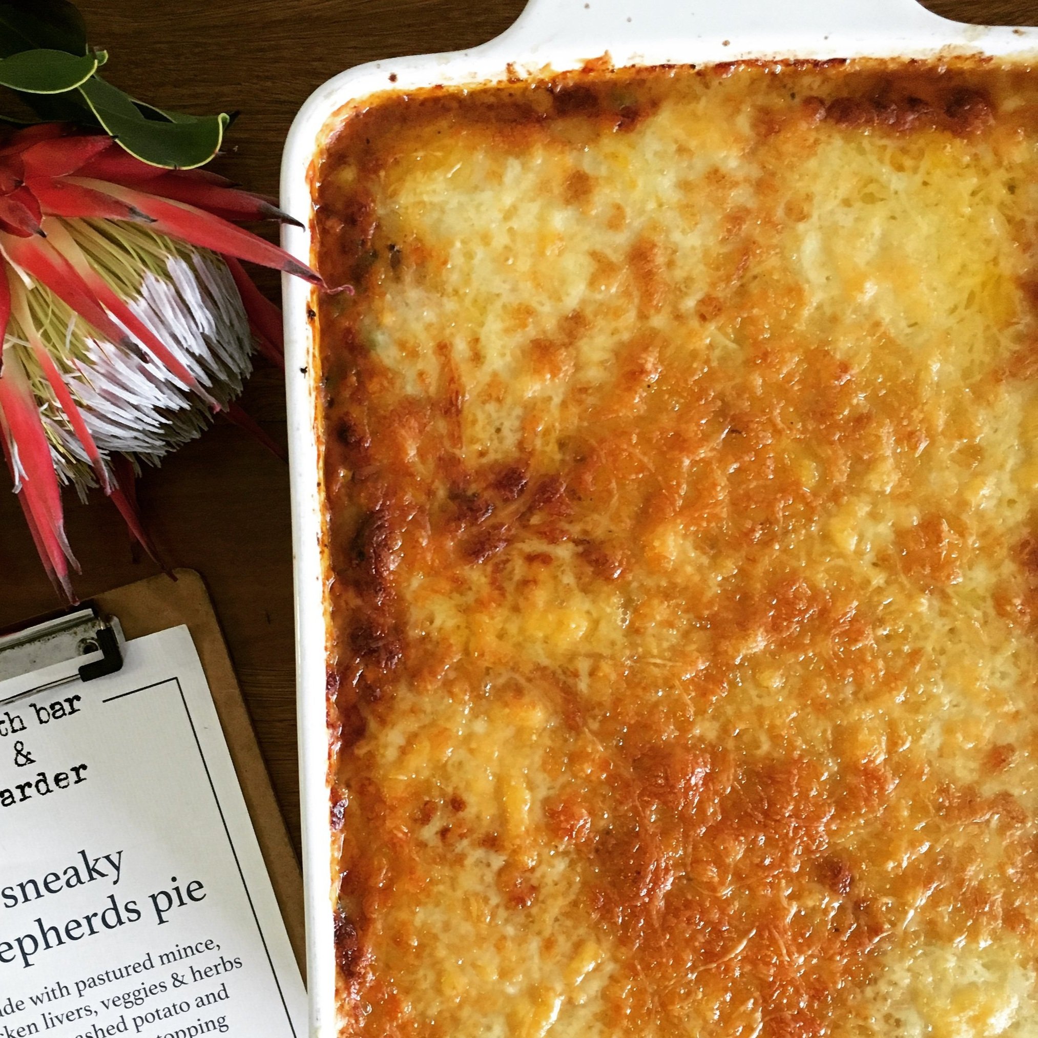 Top view of baked shepherd’s pie with gruyere cheese crust – slow-cooked with clean, nourishing ingredients