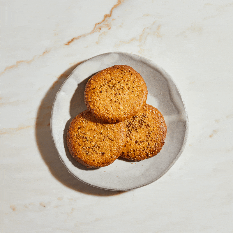 Two golden gluten-free lactation biscuits with fennel seeds and cinnamon – breastfeeding-friendly treat