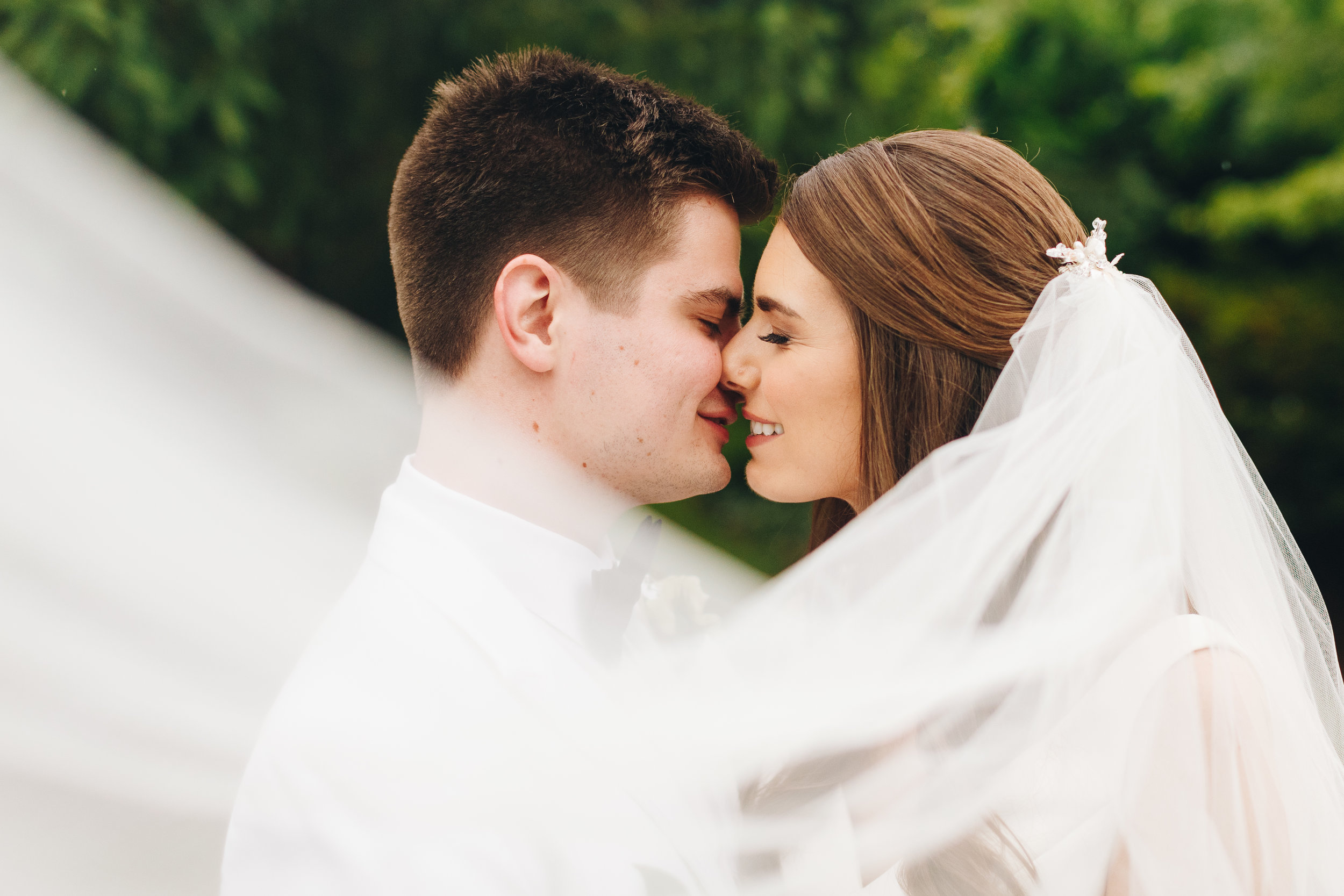 Intimate wedding portraits under a veil