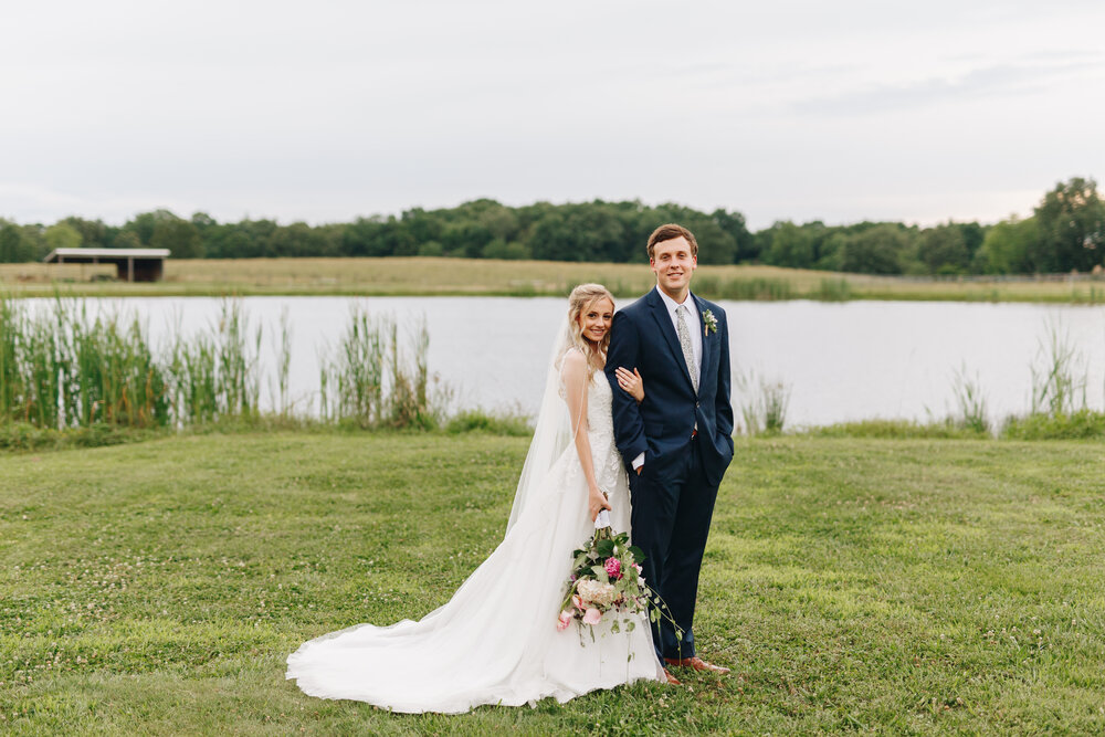 Bride and Groom by a pond on a farm