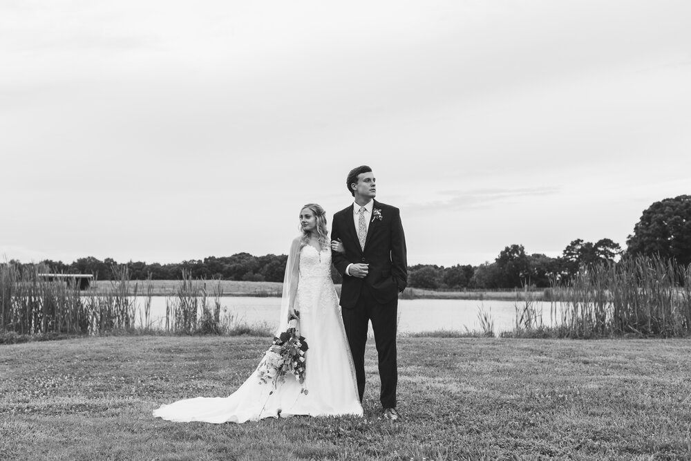moody bride and groom portraits by water