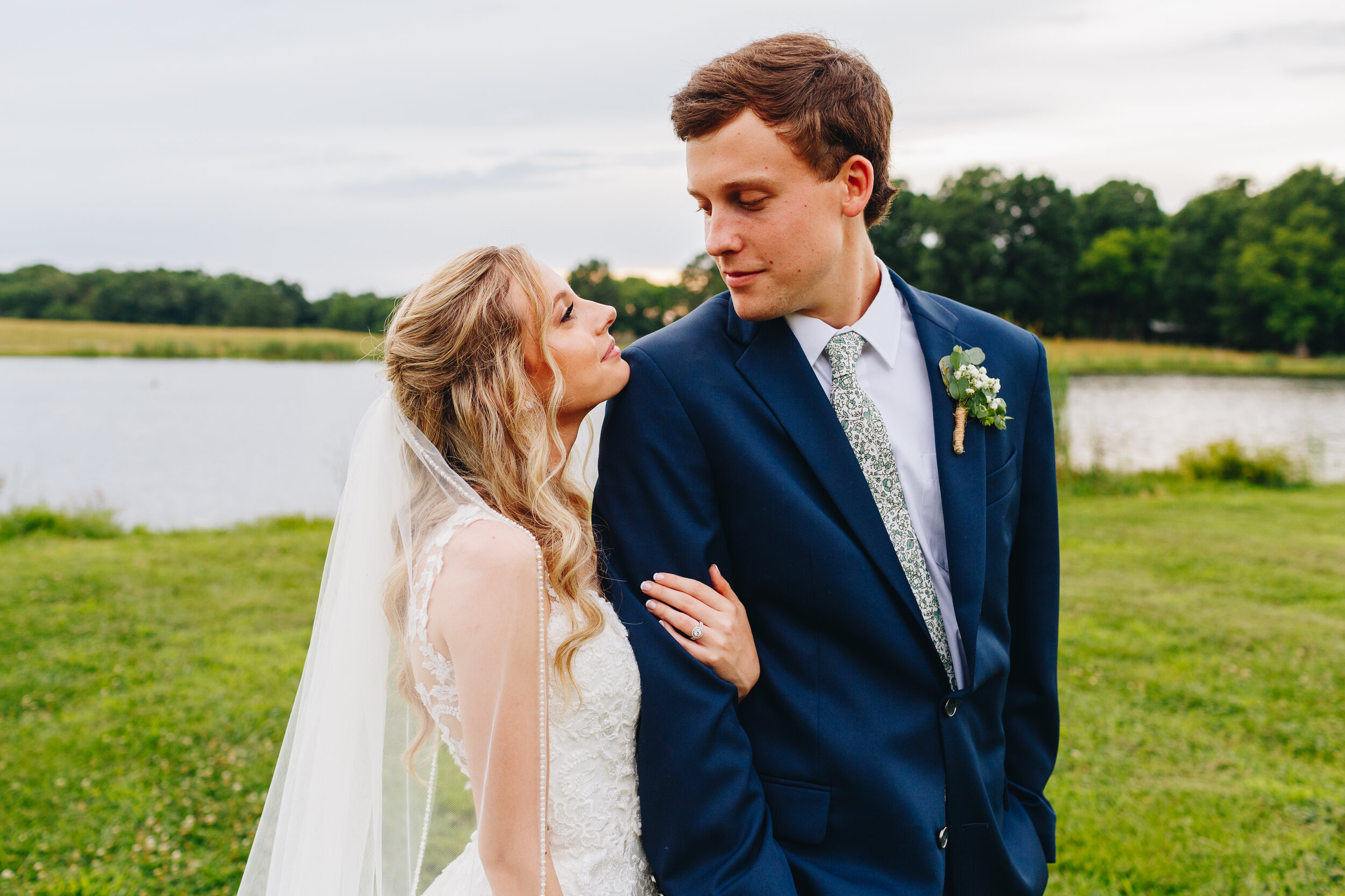 Bride and groom portraits by water