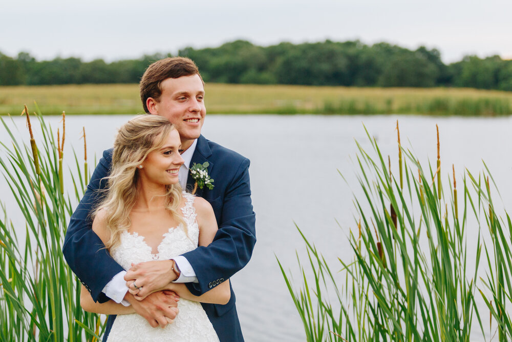 Bride and groom portraits by water