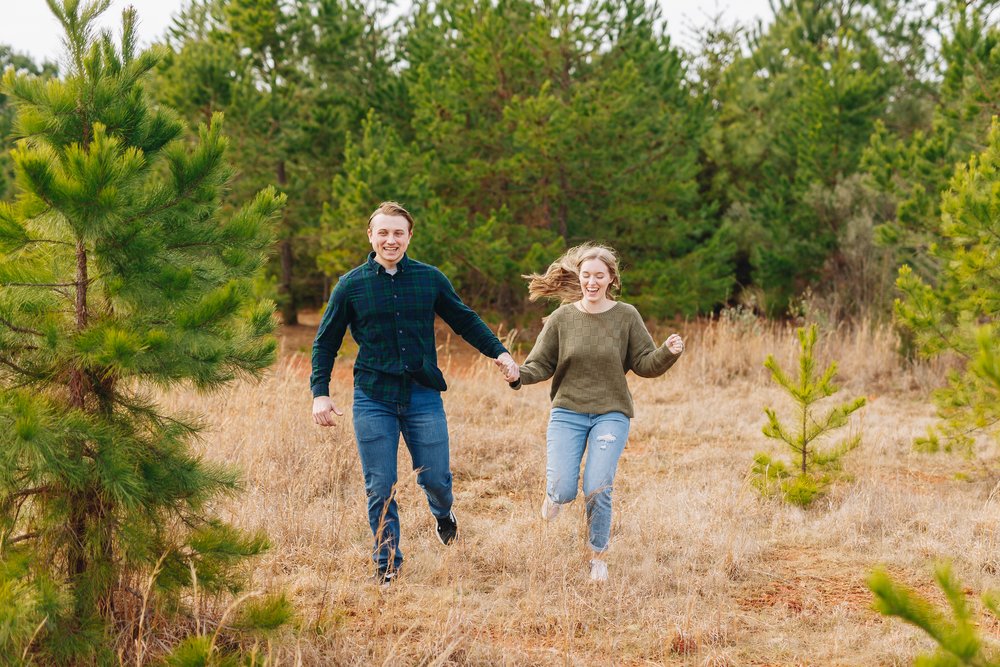 running in a field engagement portraits