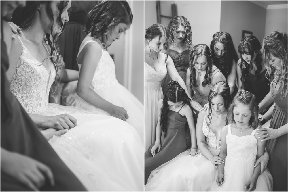 bridesmaids pray over bride photo