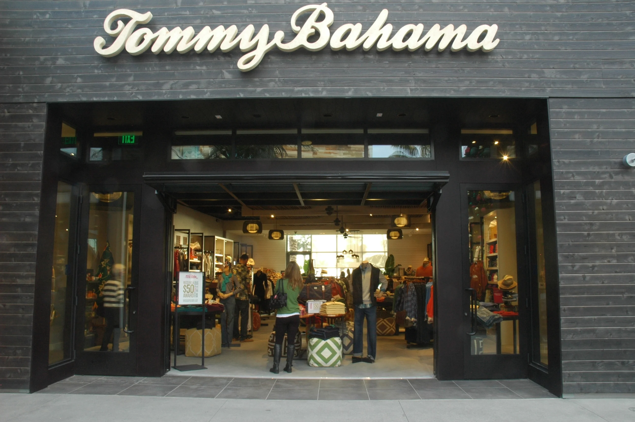 This retail store is located in the Pacific City development across the PCH from the Pacific Ocean in Huntington Beach California. The unique concept for this store targets and plays off the beach centric demographic local to the area. Natural and honest materials fill the space featuring concrete floors, a custom reclaimed wood ceiling, whitewashed wood walls and a blackened wood storefront. A large and inviting hangar style garage door greets the guest, the merchandise and view draws the visitor deeper into the space. Strategic merchandise lighting and ambient feature fixtures are used to create a more homelike feel.