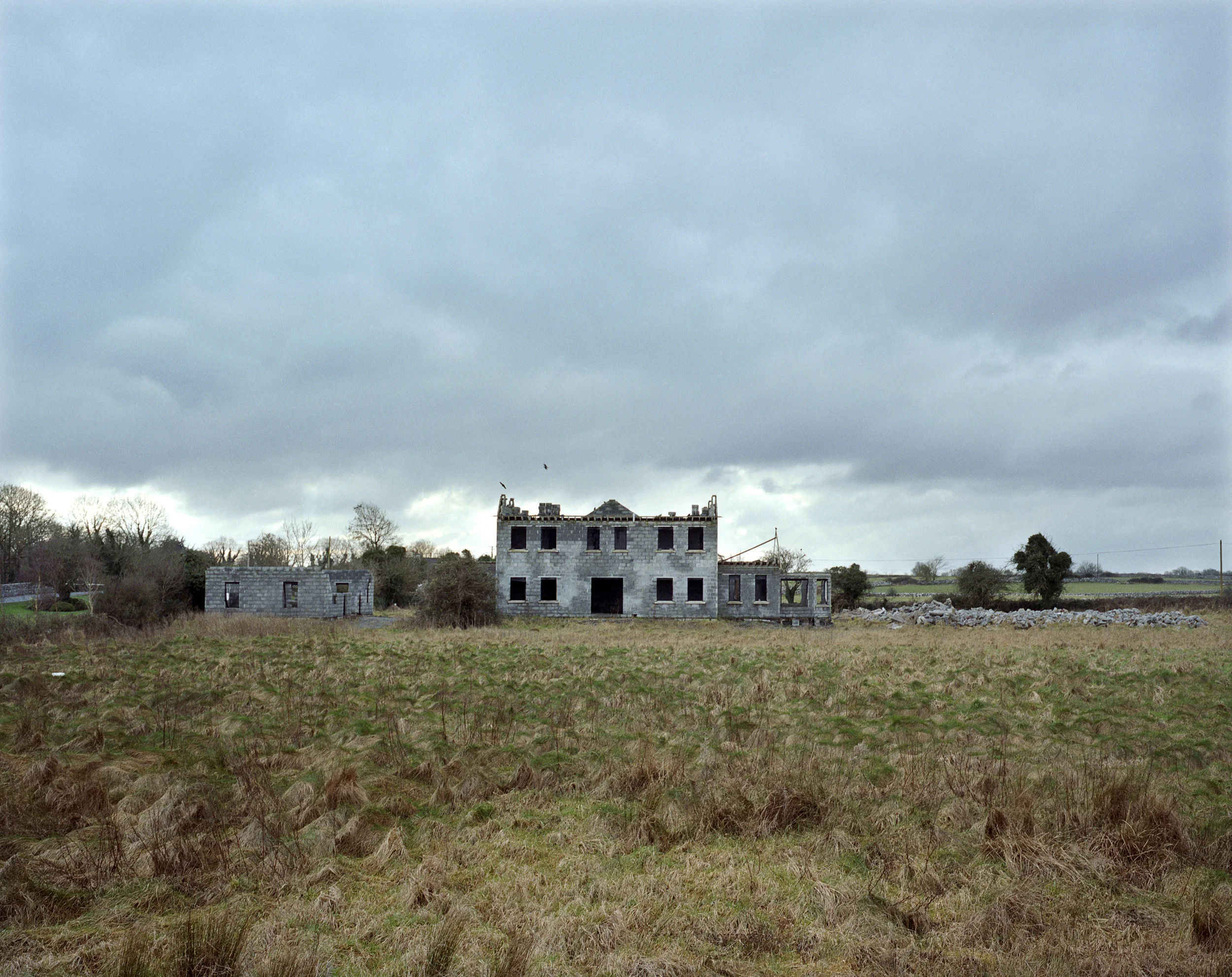 For 10 years, Ireland’s boom just got “boomier”, in the words of former Taoiseach, Bertie Ahern. From 1996, house prices rose without a break, pumped with the most potent drug of all : cheap credit and plenty of it. Flimsy financial regulation, tax incentives and soaring numbers of economic immigrants - many of them put to work on construction, thereby creating a vicious circle – ensured that property became the dinner party staple of the era. An unholy alliance of builders, developers, estate agents and bankers became the new gentry, mad with hubris, prospering in a culture of greed masquerading as entrepreneurship. Their conspicuous lifestyles - trophy homes, multiple holiday villas, yachts, helicopters and the occasional private jet - were not only accepted, but admired as the well-earned fruits of their buccaneering labours. At government and local level, politicians facilitated the developers, riding roughshod over planning principles and re-zoning parcels of agricultural land in areas unfit for development. Landowners became multimillionaires overnight, as the builders moved in to throw up insanely over-priced suburban-style houses in rural locations, all of it . financed by bankers driven by rivalry and minimal oversight. Developers never had to worry about turning a profit, thanks to extraordinary house inflation, fast becoming a bubble. As desperate young couples were forced further from the city for affordable homes and overnight queues became a common feature of new home launches, agents and developers found new ways to milk the frenzy. Where before, phases one and two of a development might be a year apart, the greed fest reached a pitch where an apartment advertised at 270,000 on a Thursday morning could be hiked to 295,000 in a so-called “Phase 2” that same afternoon. Between 2000 and 2007, residential mortgage lending surged by more than 300 per cent - from 29 billion to 123 billion. The disease was contagious. In the 10 years from 1996, as the Dublin region saw a 366% rise in property values – from an average of €82,400 to €384,247 - many with modest homes in the most non-descript suburb came to believe they were sitting on a goldmine and borrowed gleefully on the strength of it. Some came to fancy themselves as property “experts”. An age of insanity was distilled in one court case in early 2009, where it emerged that a Dublin father of three on an Air Corps pilot’s salary of 53,000 (euro), had managed to build up a twelve-house property portfolio, with loans of 8million euro from nine separate financial institutions. The common belief, it seemed, was that cheap credit and immigration would last forever. We were invincible. Only a few Cassandras saw the turning in the road. The giddy rise in house prices skidded to a halt when the European Central Bank raised interest rates in 2006 and 2007. Construction sites closed abruptly and tens of thousands of workers were thrown out of work, many of them the immigrants on whom much of the future housing demand relied. Banks and developers on a giddy round of musical chairs were caught when the music stopped. Our crash was even “crashier” – to borrow Bertie’s unique word treatment – than any other country in Europe The true value of half-completed housing developments on stunningly obscure sites in the so-called commuter counties lies savagely exposed. Agricultural land bought for astronomical sums at the height of the boom are reduced to wasteland. “Zombie” hotels, “ghost” estates and mothballed apartment blocks mock the hubris of another era, like the desert kingdom of Ozymandias : “Look on my works, ye Mighty, and dispair!”.