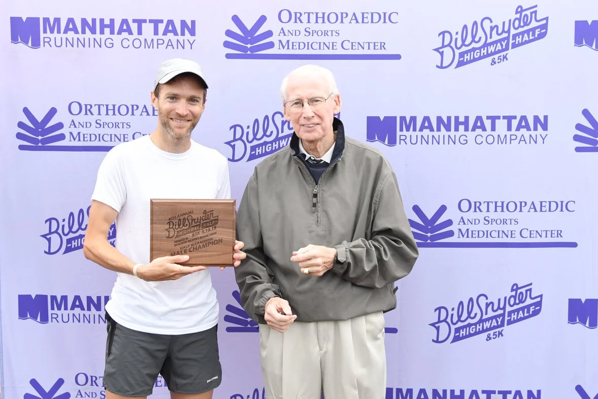 Joe Moore, 5X Champion getting his award from Coach Bill Snyder