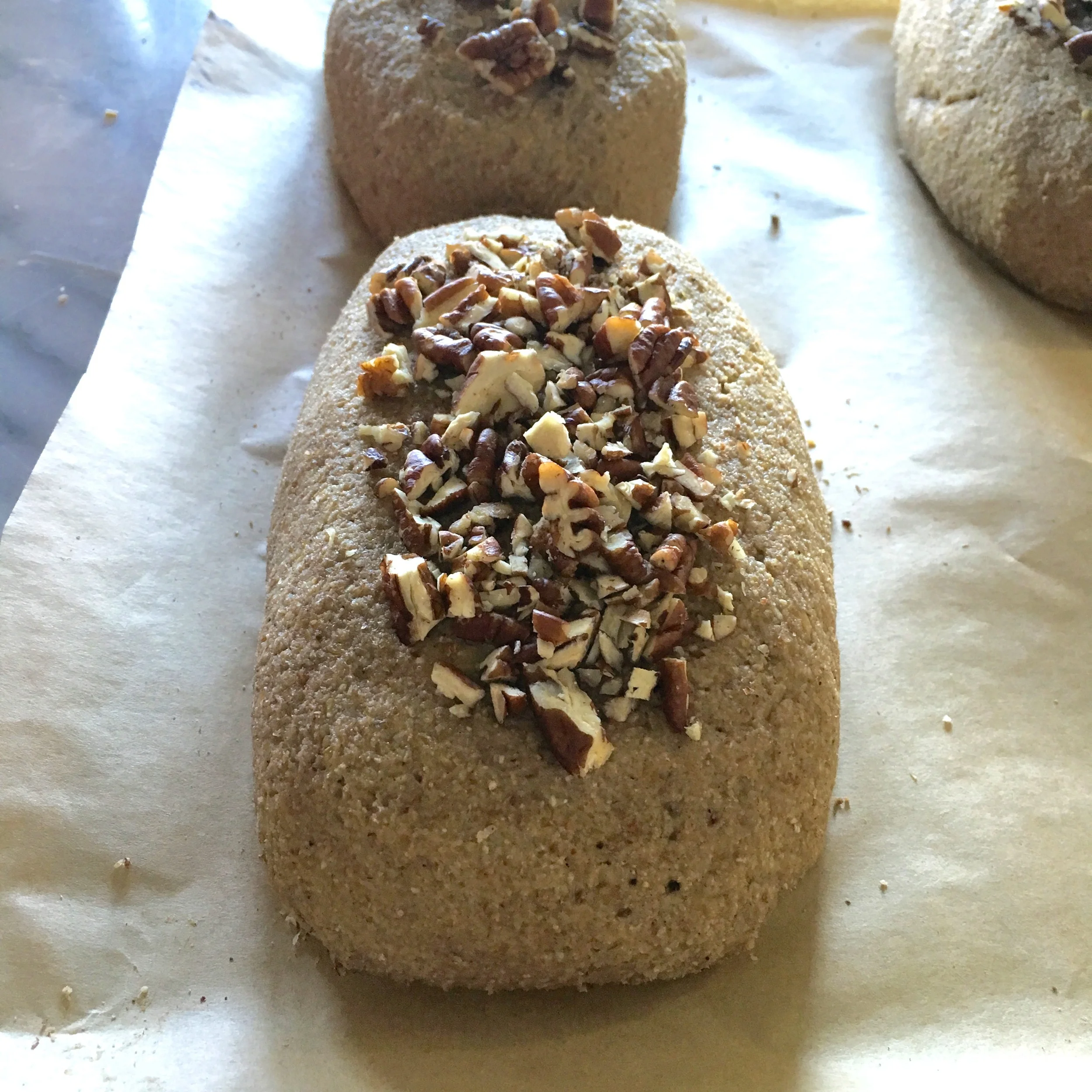 Raw banana bread topped with pecans - ready to be frozen for the mixture to set and to be dehydrated thereafter for bread to be warm 🍌🍞