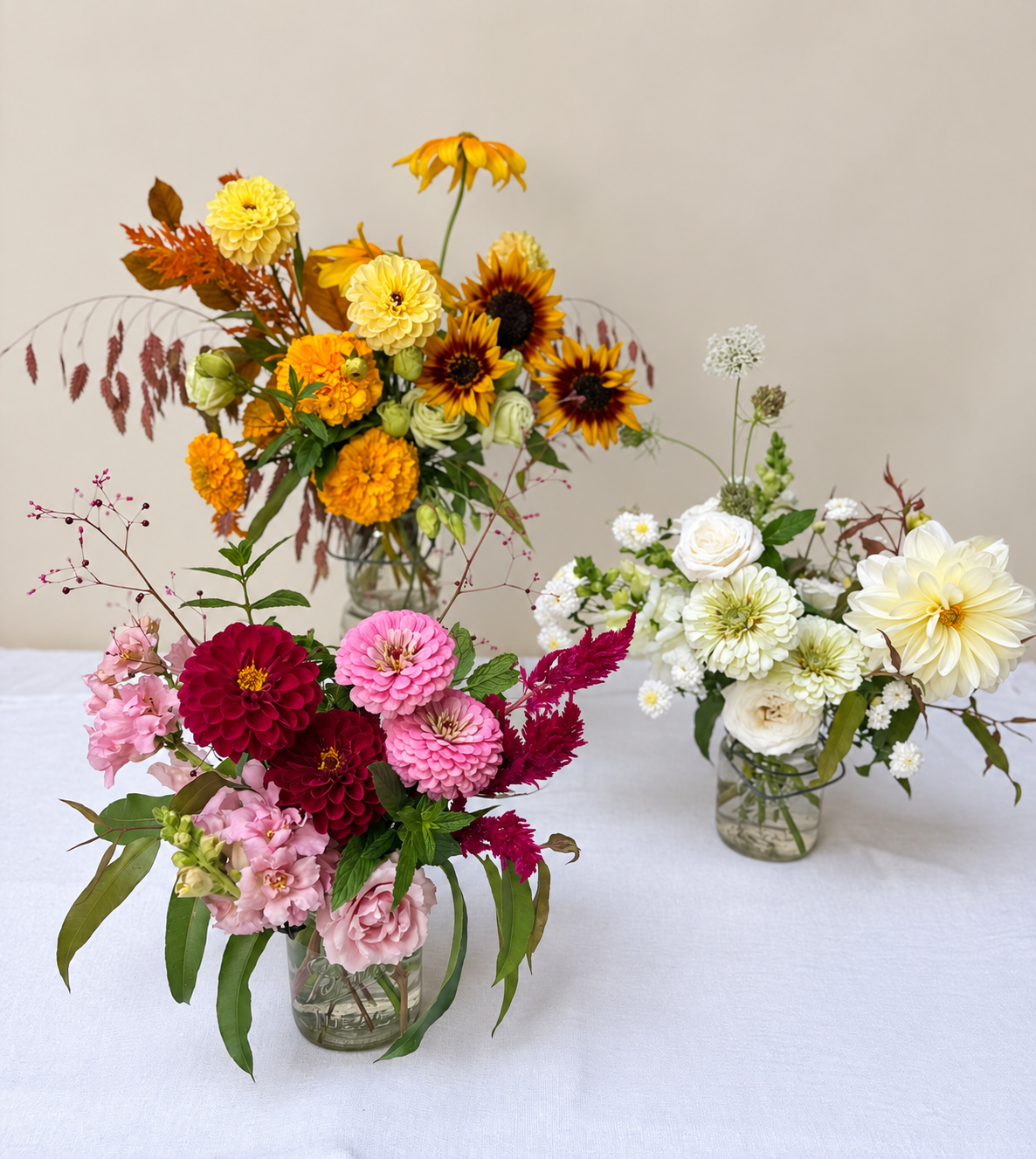 Three floral arrangements in soft light.png