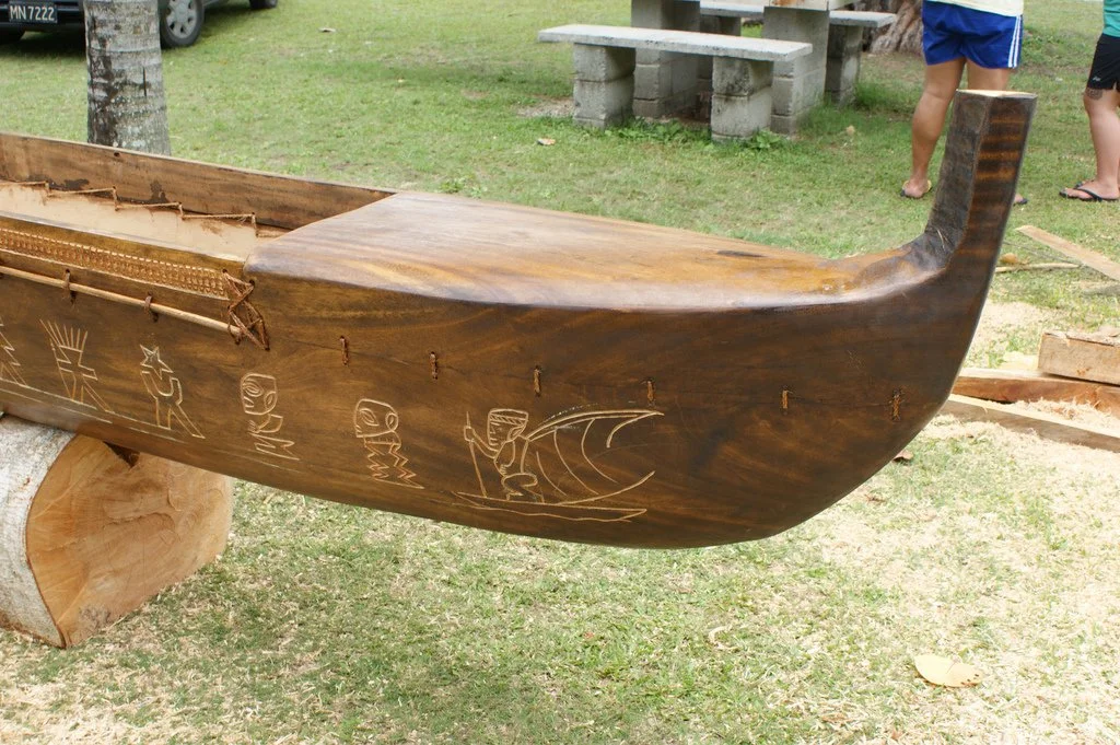  Canoe in Rarotonga,  Cook Islands.  I t has a front  top very similar to those in Hawaii. Note the carvings along the hull. 