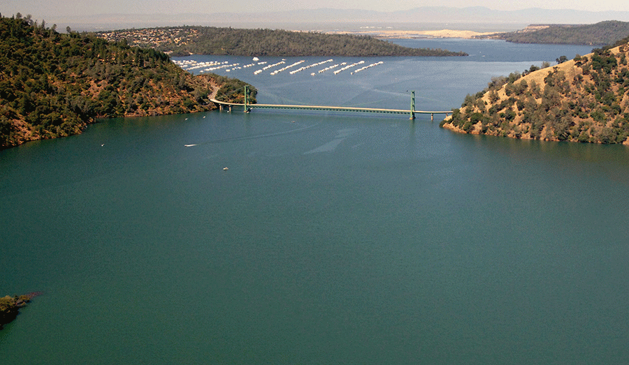 The Enterprise Bridge passes over full water levels at a section of Lake Oroville near the Bidwell Marina on July 20, 2011, in Oroville, California, followed by current drought levels on Aug. 19, 2014. Credit: California Department of Water Resources / Getty Images