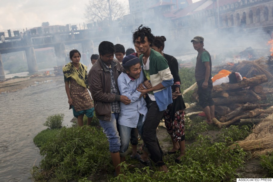 A Hindu man breaks down during a funeral for Saturday's earthquake victims on the Pashupatinath bank of Bagmati River, in Kathmandu, April 26, 2015. (AP Photo/Bernat Armangue)