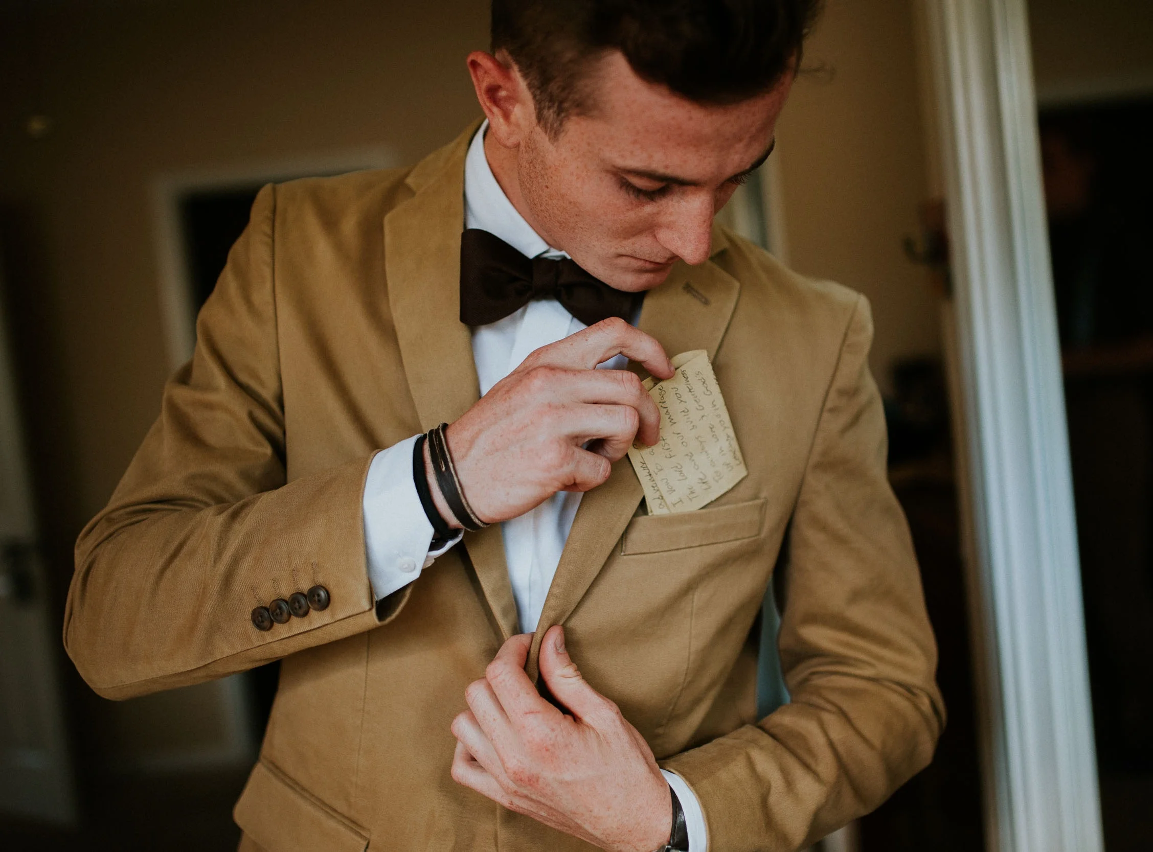 A photo of a groom preparing his vows for his ceremony. Shot by David C. Allen Photography