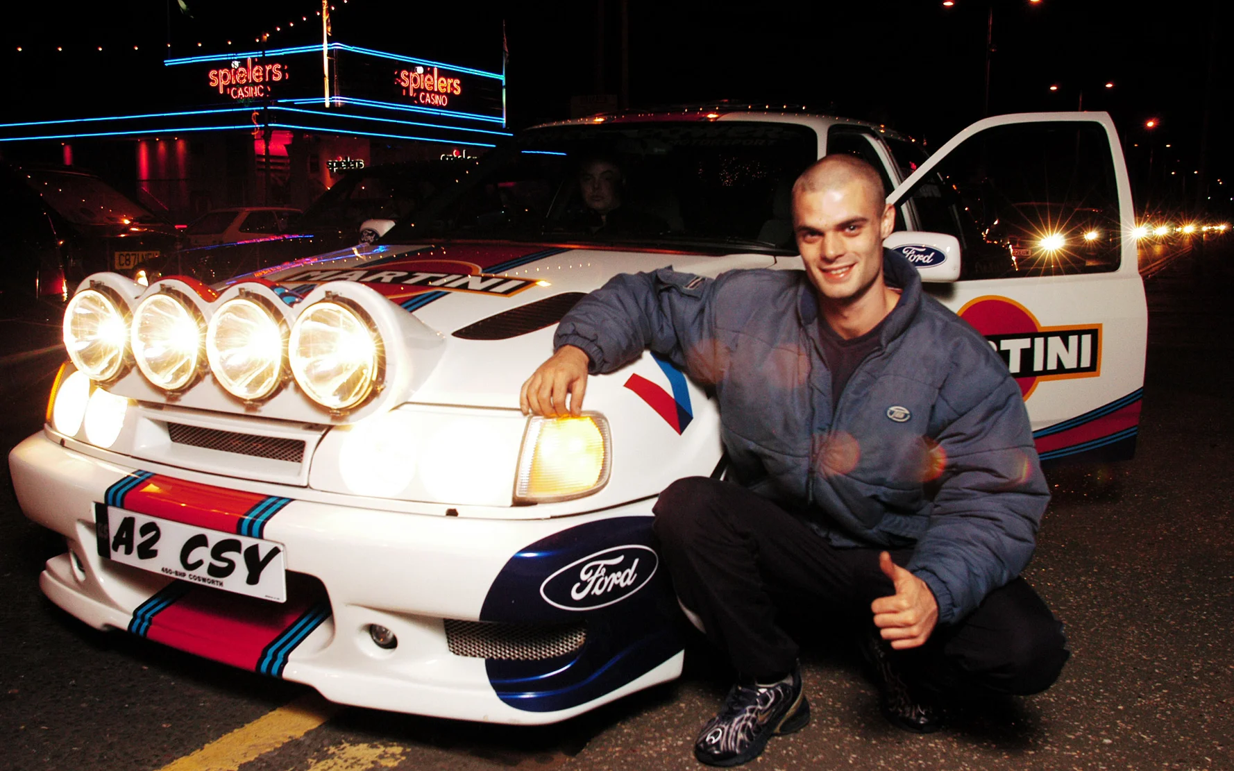 A boy racer posing by his customised Cosworth, Southend, Basildon, 2002 © Nick Cunard / PYMCA