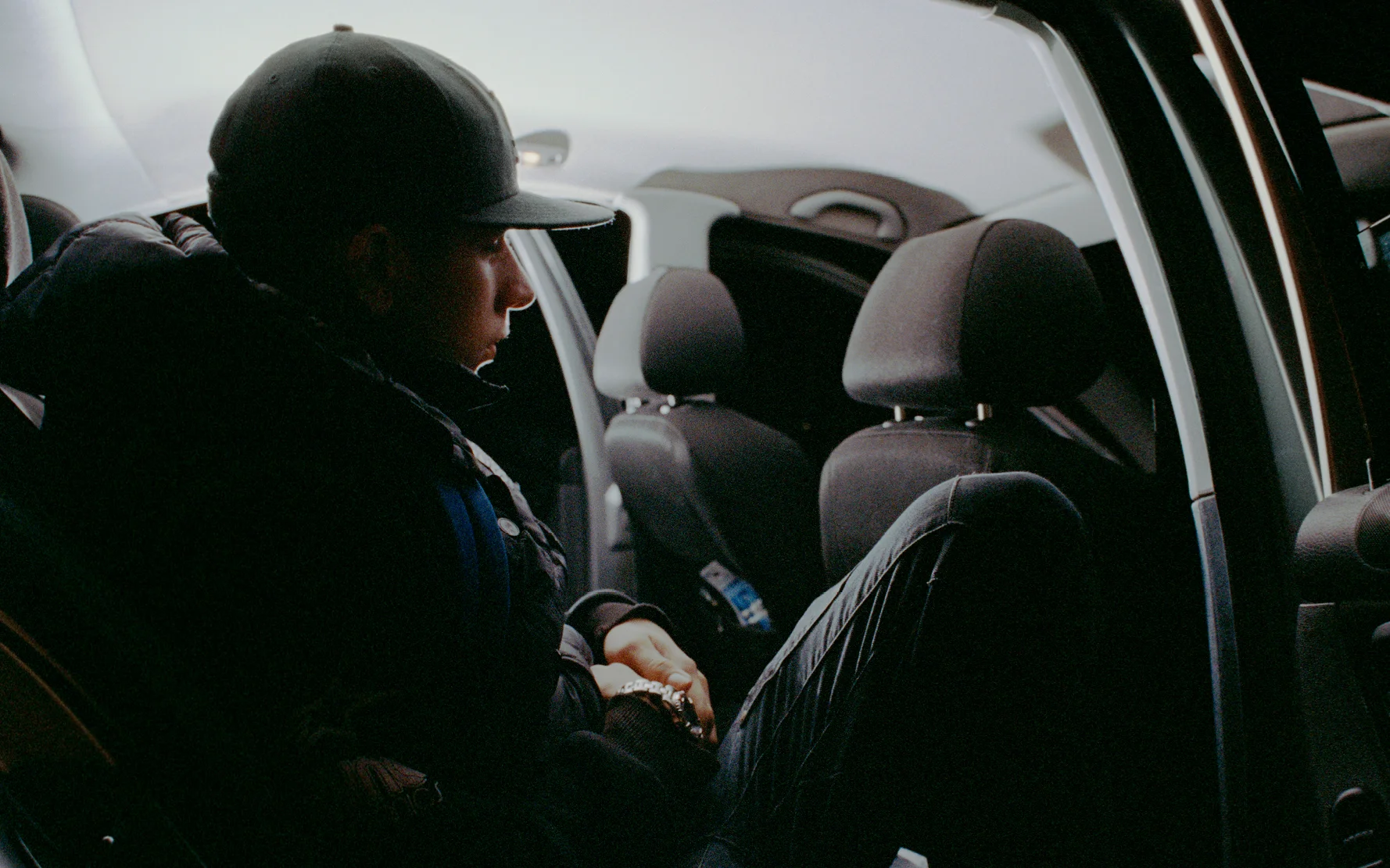 Young man sits in back of car at local "Boy Racer" meet up. Brighton 2013 © Scott Mains / PYMCA