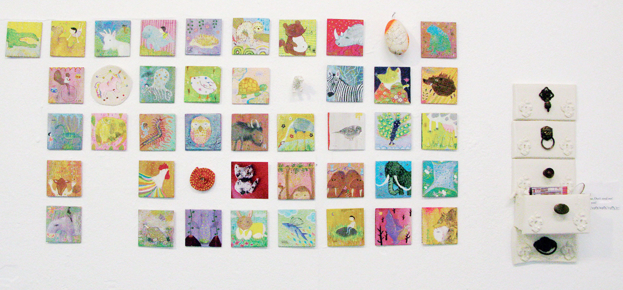“Little Drawer” was inspired by Karuta, the common Japanese card game to learn Hiragana. Different mediums and materials were used to make an impression of knick knacks that could be found in a forgotten drawer. Artwork medium: Mixed media on 3½”x 3½” wood (paintings), ceramic (drawers and cheetah shown above), cplaydough (snake), photography (cat) and embroidery (unicorn).