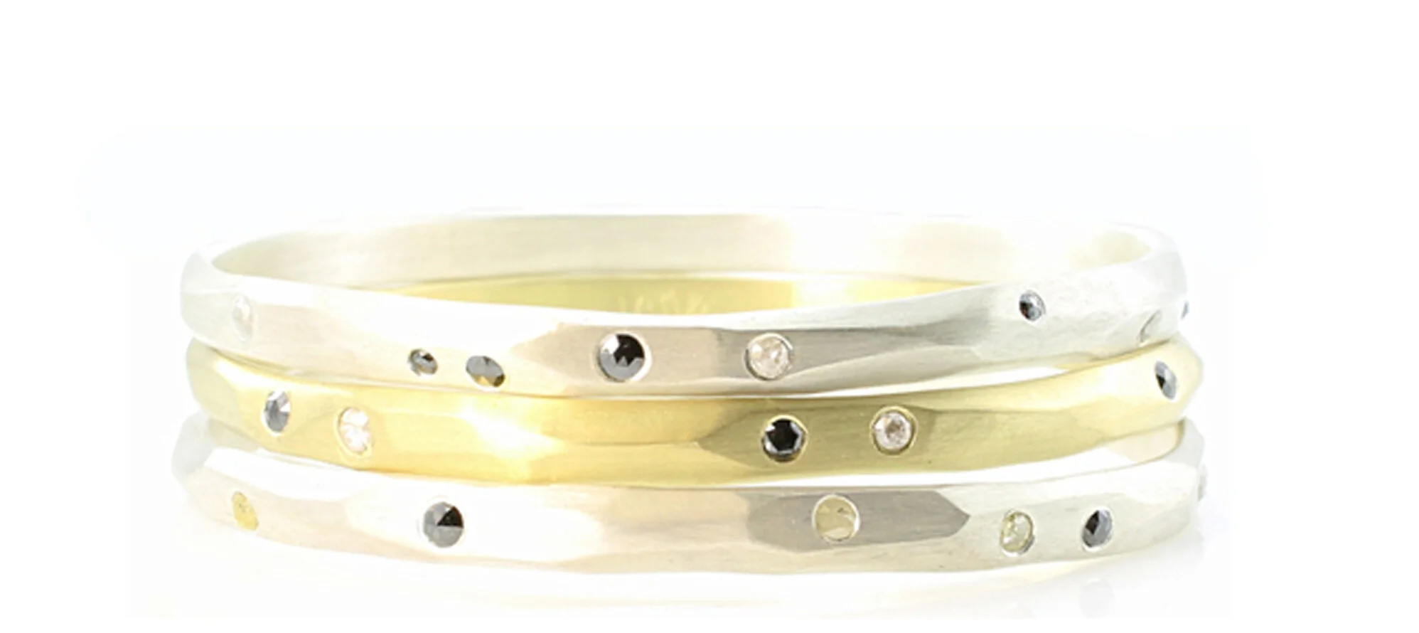 Carved, solid 18k gold and sterling silver bangles with flush-set diamonds