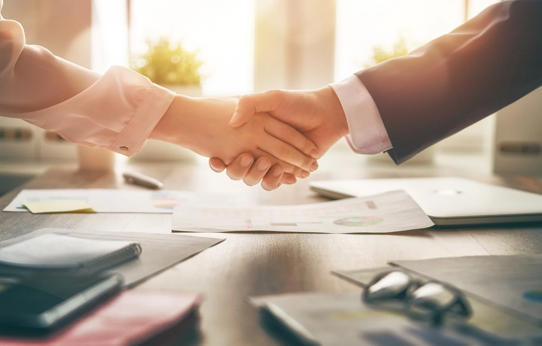 woman man handshake across desk-reduced.jpg