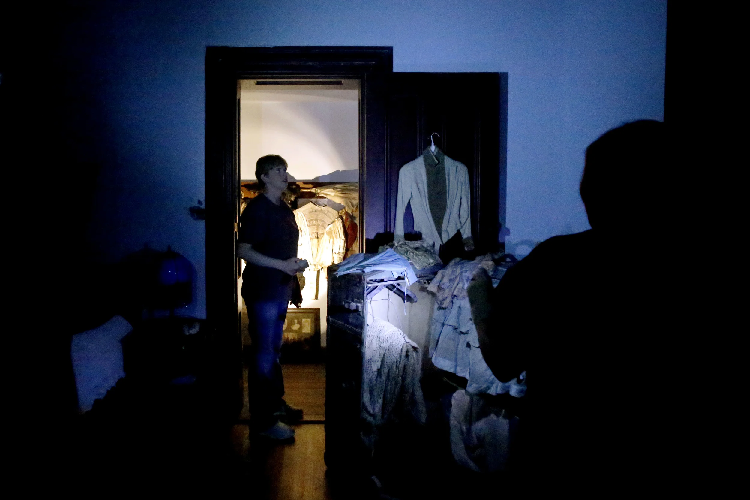 The LIPS team investigates Nadine's room at Ravenswood in Bunceton, Mo. Saturday, Oct. 25, 2014. During their previous investigation in June, 2014 Angela Rutherford, a member of the LIPS team, had heard noises coming from above them in Nadine's closet. They check again to see if they could hear the noise again.