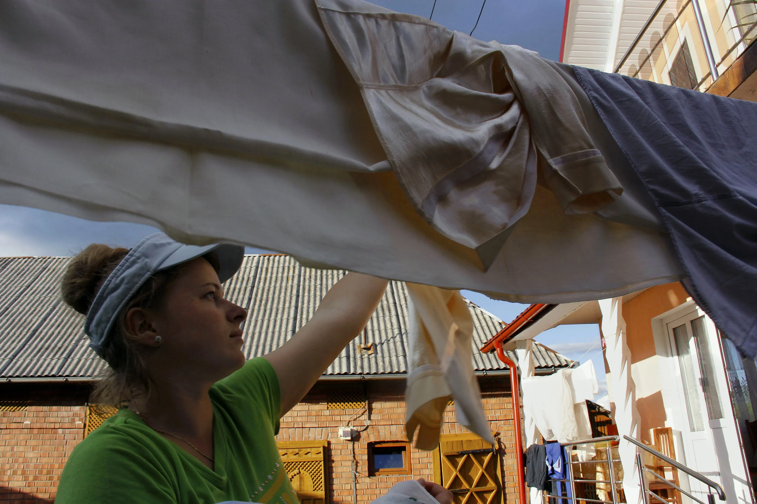  Taking the laundry from the clothes line to fold and put away. "I don't mind doing chores," Marii said, "I enjoy having things clean." 