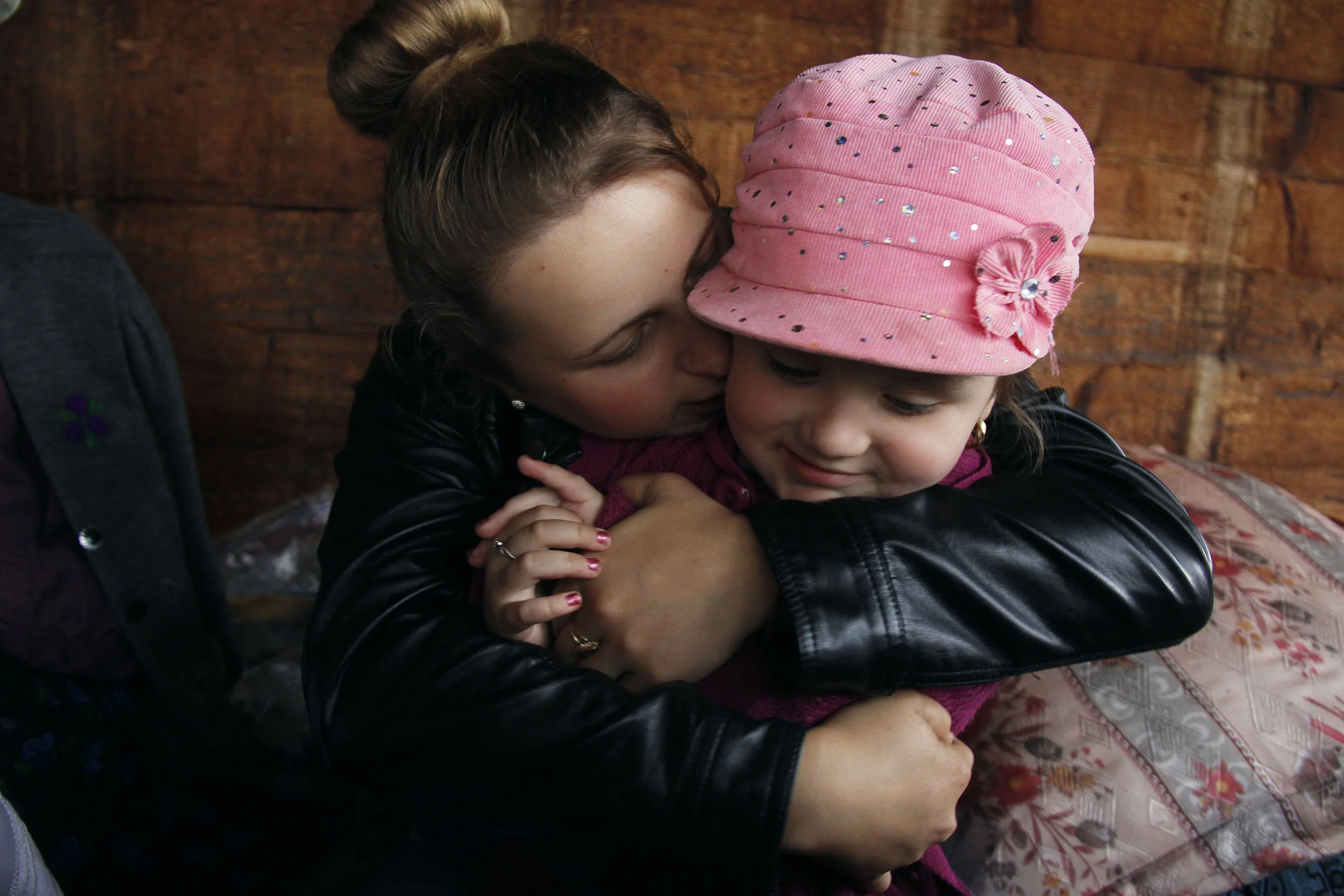  Marii is excited to see her four-year-old cousin, Alina, and holds her in an embrace. Although she only lives minutes from her extended family, she is always glad when she gets to see them. During the school year Marii must commute to her high schoo