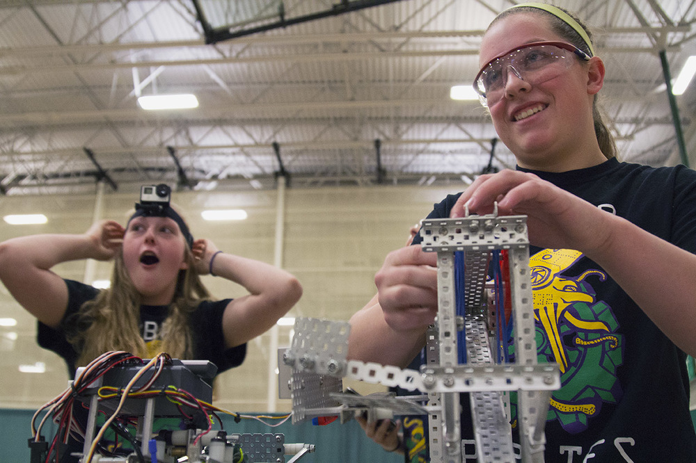  From left, Kaitlyn De Kan, 17, and Allie Floyd, 18, make final checks to their robot before they compete during the VEX Missouri State Robotics Championship in Rolla on Saturday. Kaitlyn expresses her excitement after receiving a GoPro from another 