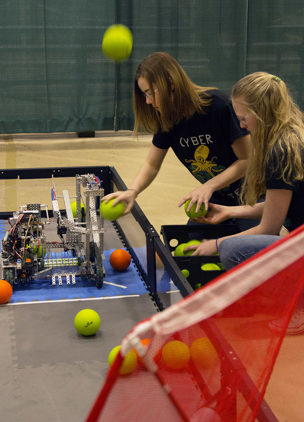  From left, Hannah Engler, 15, and Kaitlyn De Kan, 17, add styrofoam balls to their robot during the VEX Missouri State Robotics Championship in Rolla Saturday, Feb. 20, 2016. The purpose of their robot was to shoot as many balls into the net as it c
